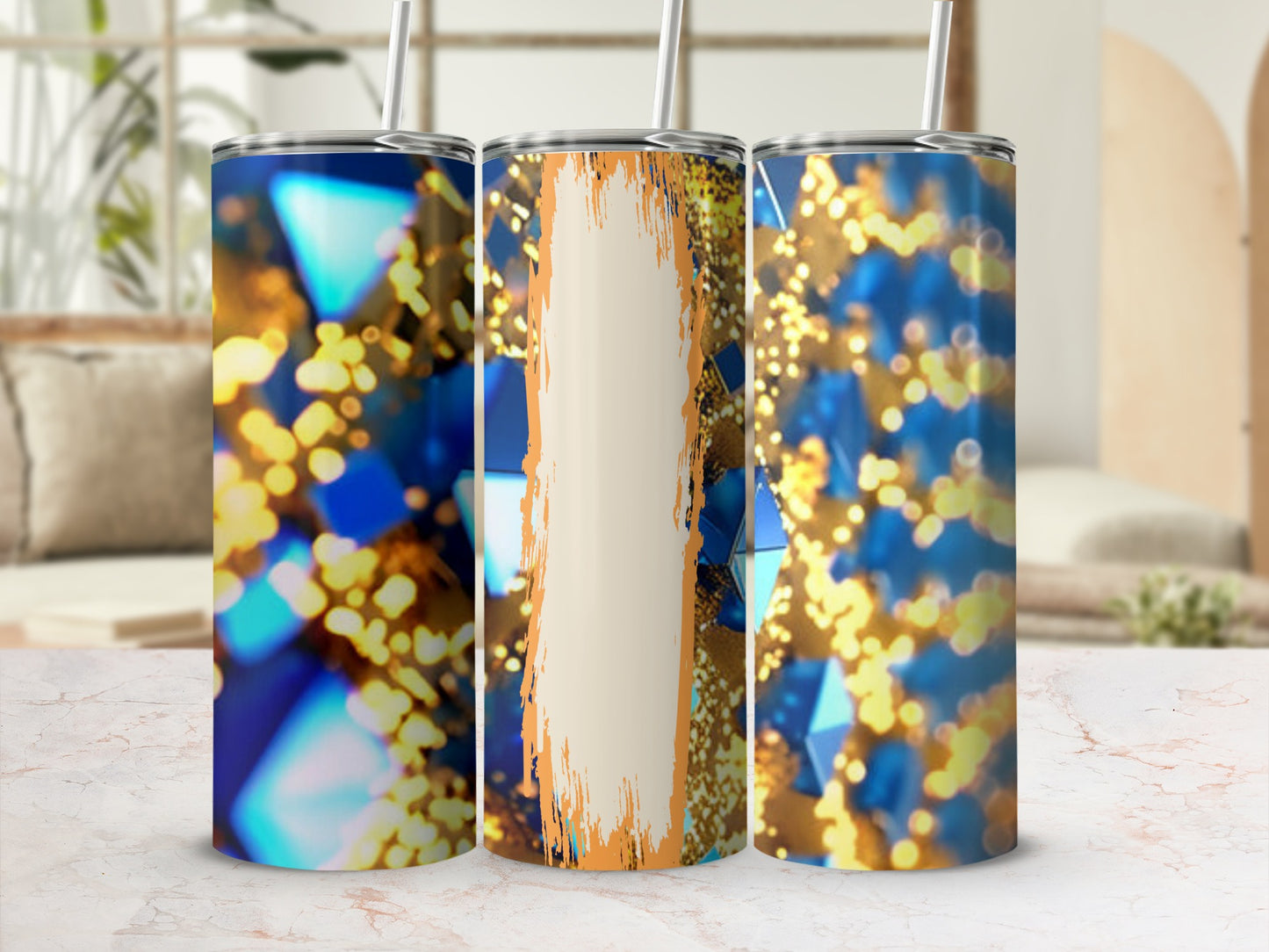 Three faceted tumblers with gold bokeh, one with a cream and orange abstract design.