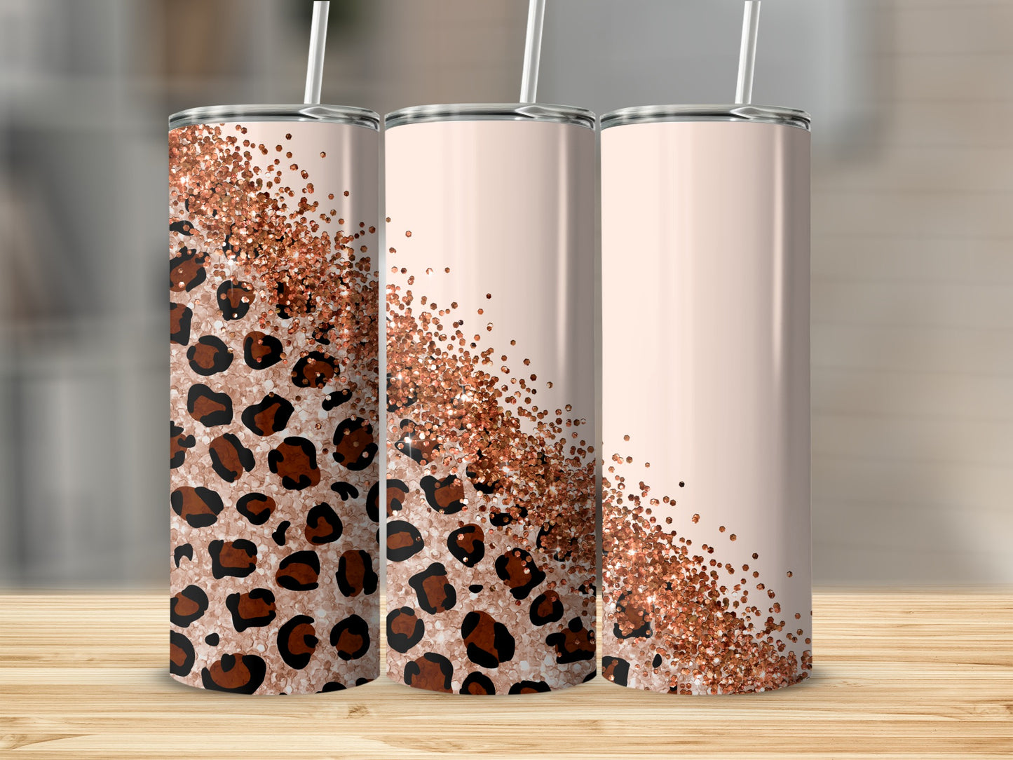 Three tall, light-pink tumblers with leopard print and rose gold glitter accents.