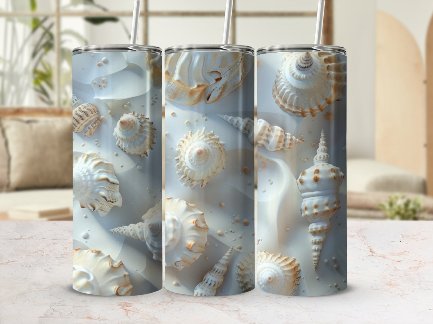 White seashells and sand patterns wrap around three tumblers.