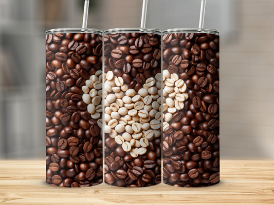 Three tumblers with coffee bean heart design on wooden surface.