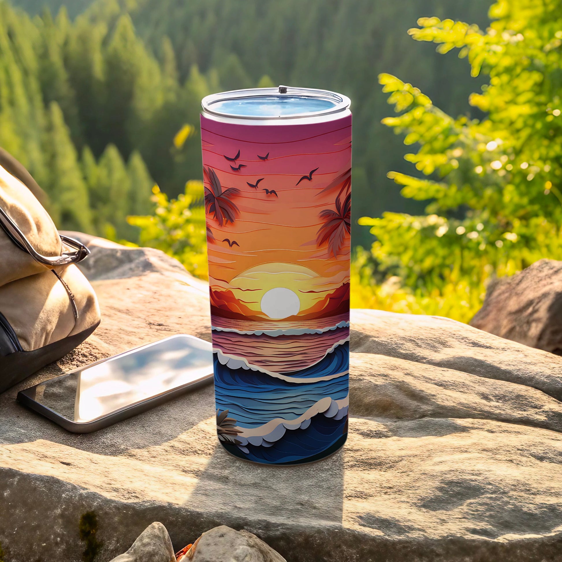 Sunset beach scene on a blue tumbler, resting on rocks with a backpack and phone.