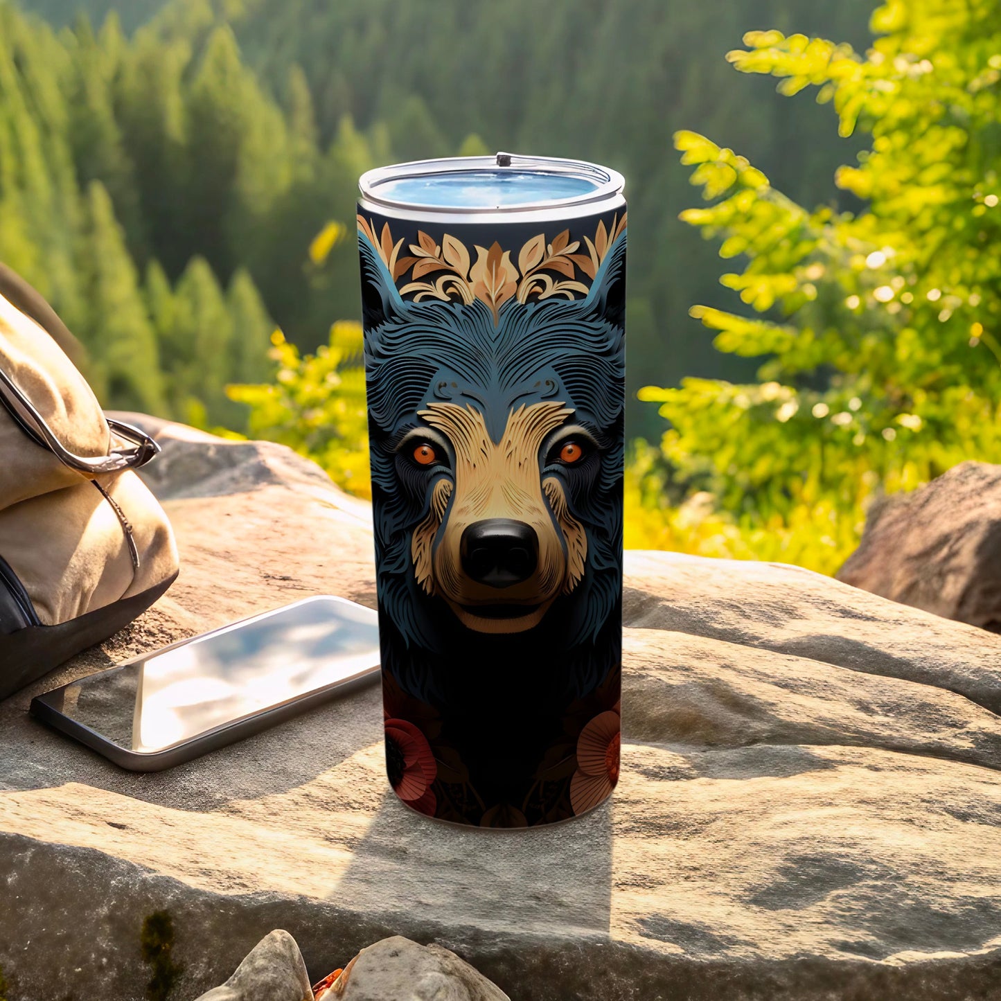 Black tumbler with stylized bear face design, outdoors.