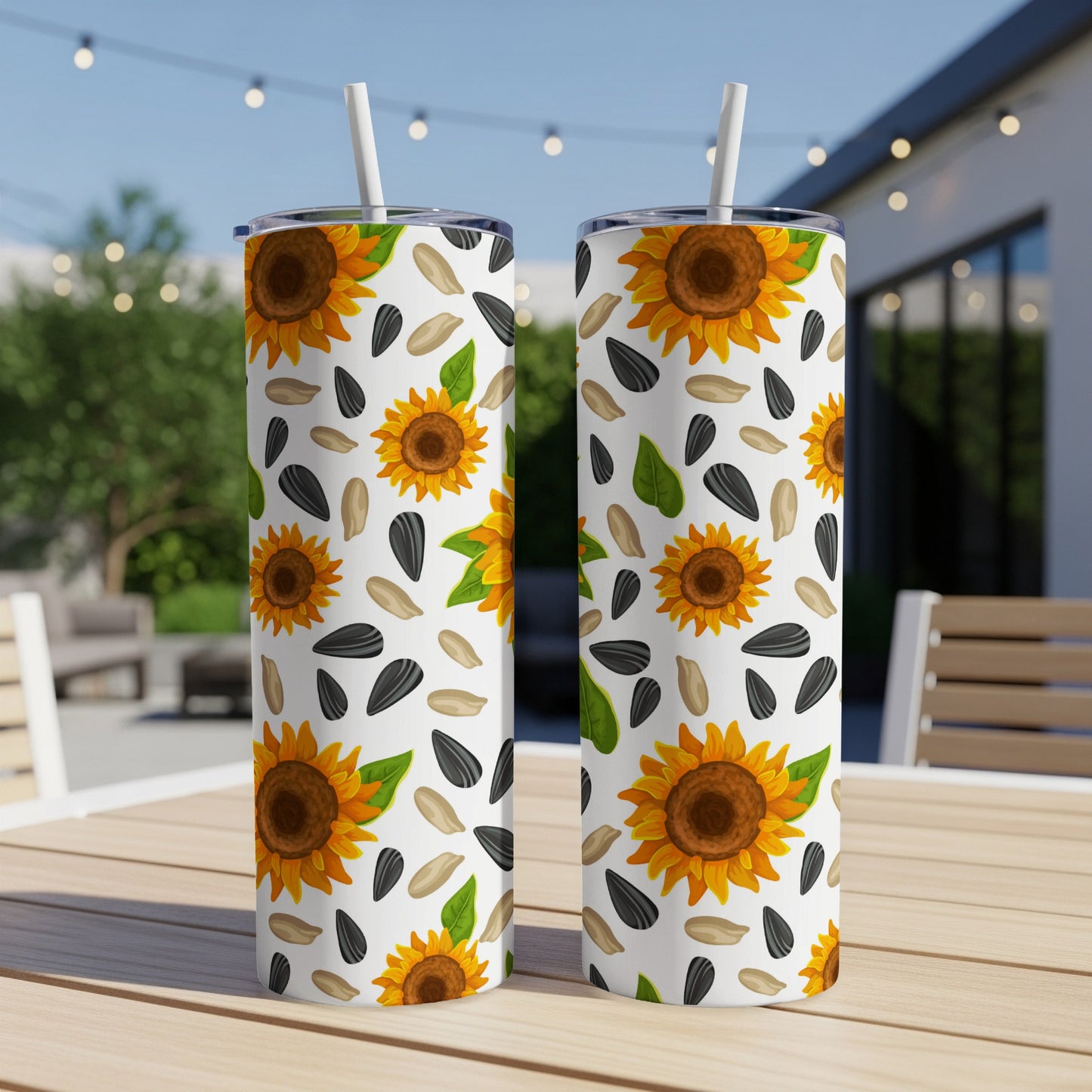 Two tumblers with a white background and scattered sunflower and seed pattern.