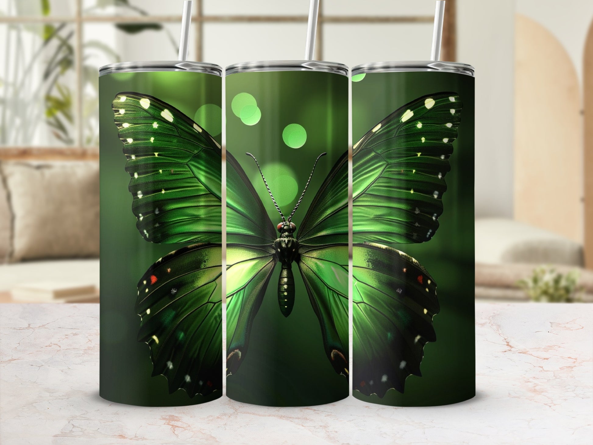 Green butterfly design on three tumblers with straws.