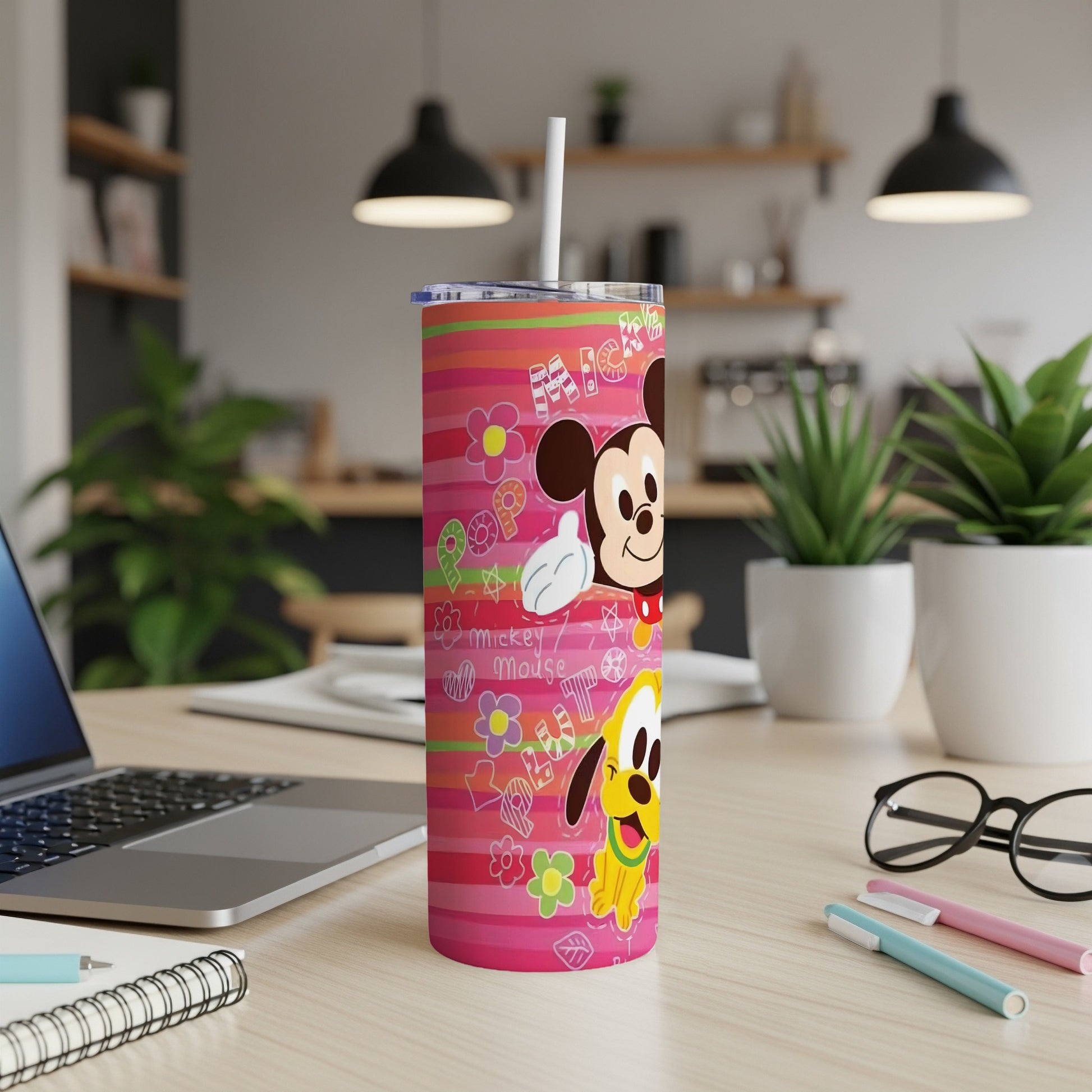Mickey Mouse and Pluto on a pink striped tumbler with floral designs.