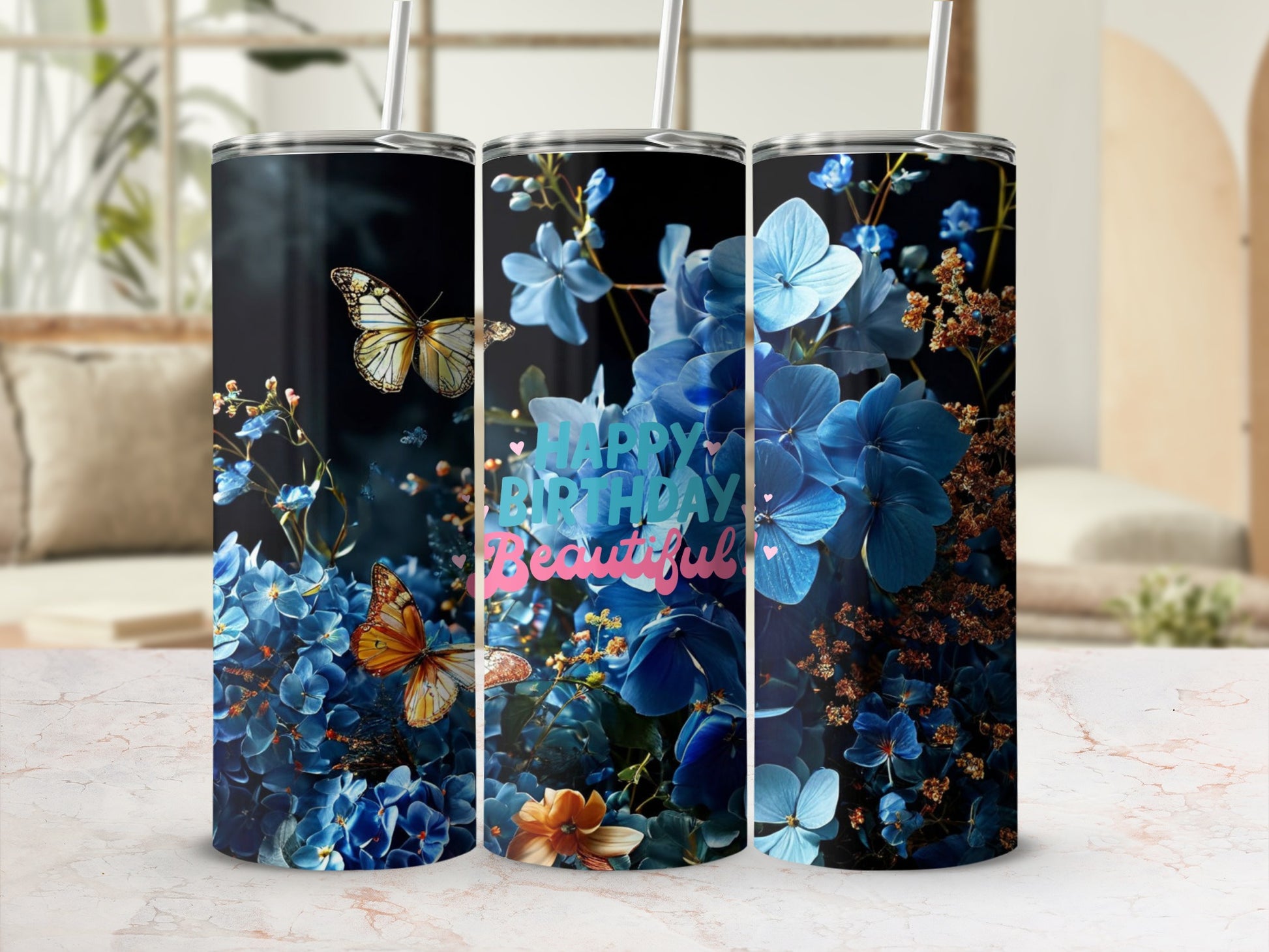 Tall tumbler with blue flowers, butterflies, and "Happy Birthday Beautiful" text.