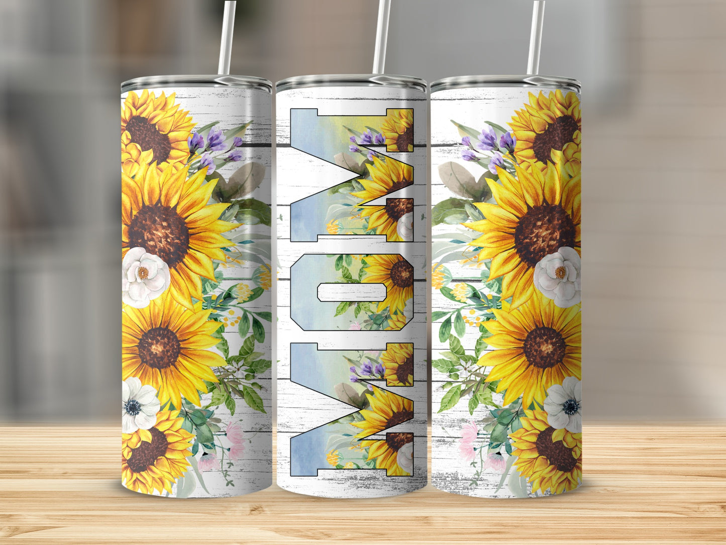 Three tumblers with sunflowers and "Mom" text, set against a wooden background.