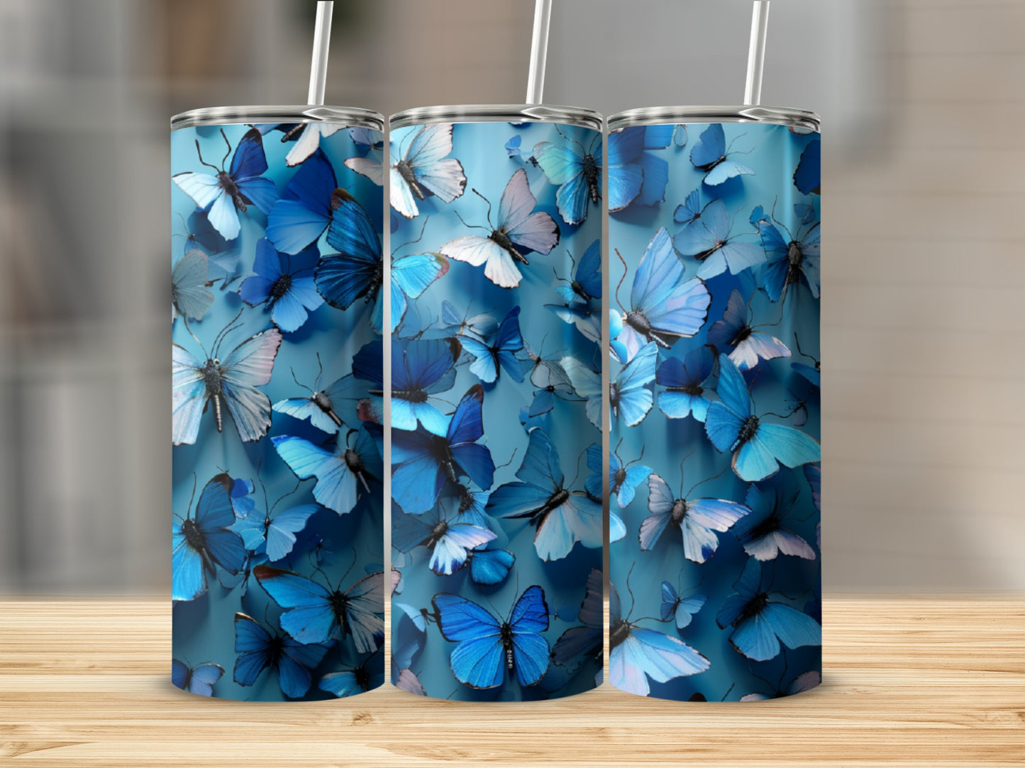 Three blue tumblers with repeating butterfly pattern.