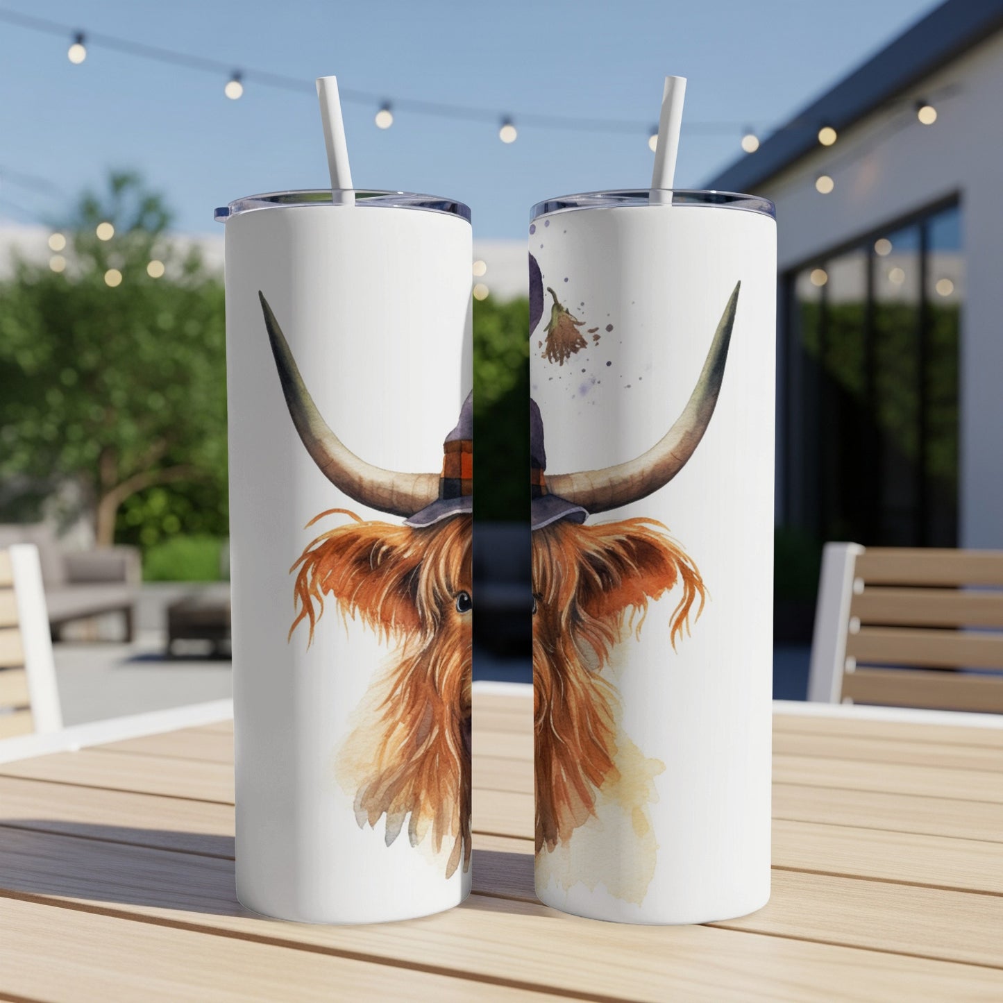 Watercolor Highland cow wearing witch hat, depicted on two skinny tumblers.