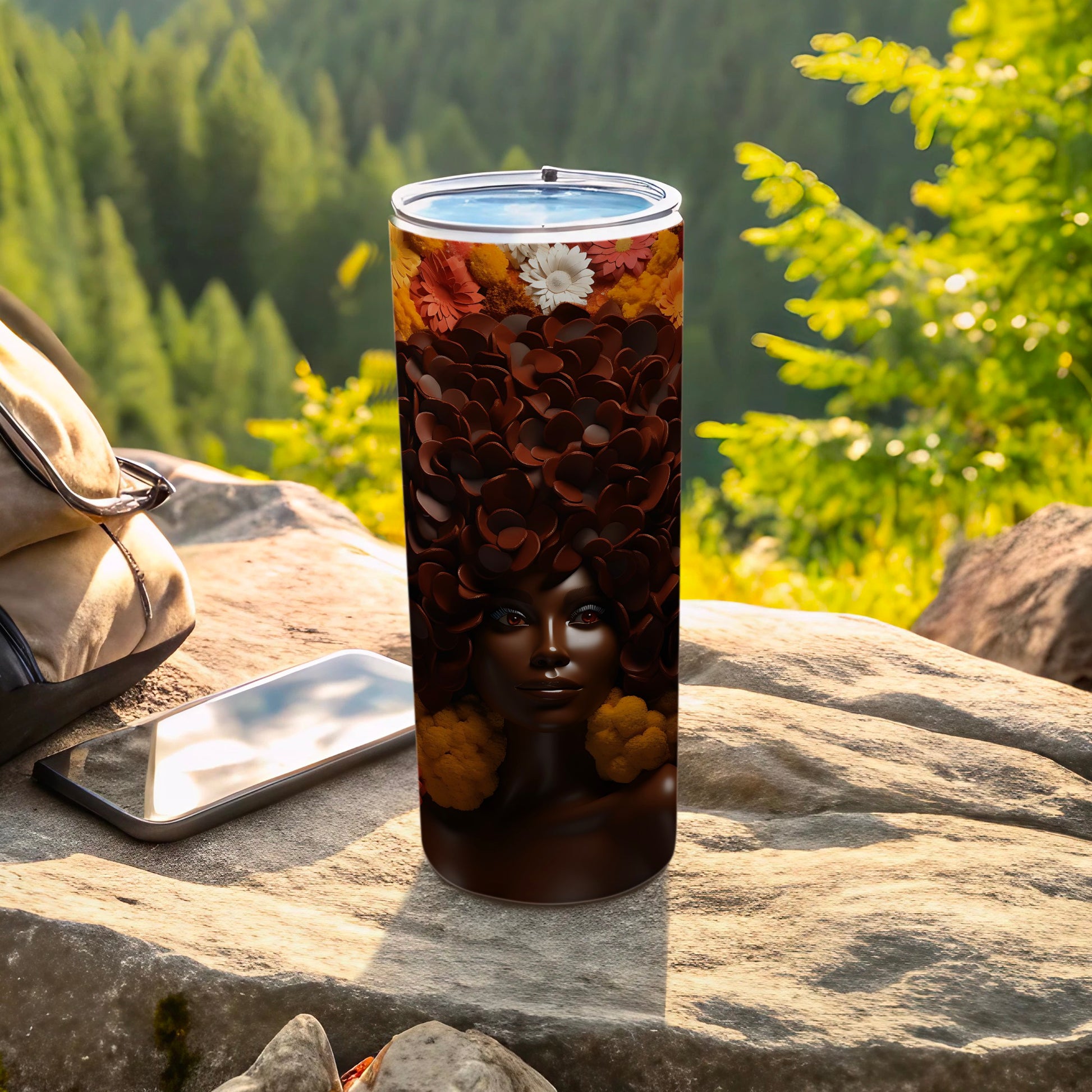 Tumbler with woman's face design featuring floral hair and fall colors.