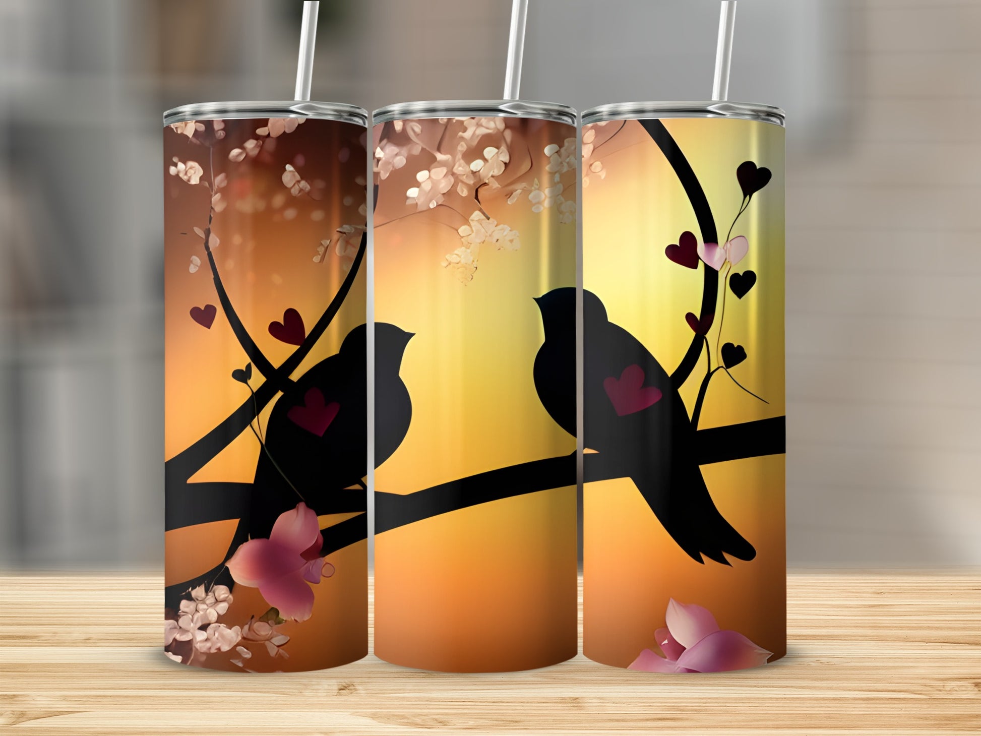 Two silhouetted birds perch on a branch with hearts and blossoms against a sunset.