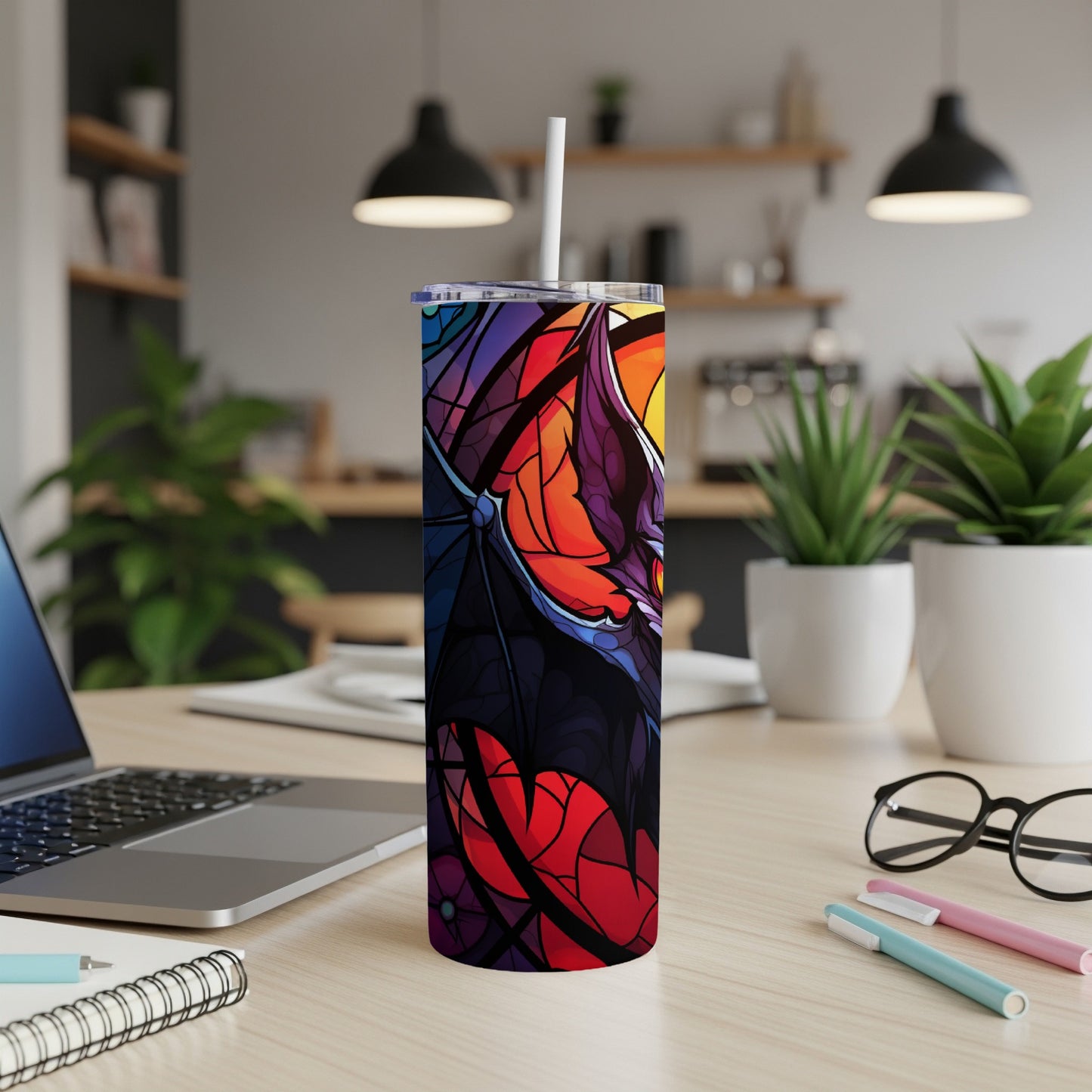 Colorful stained glass bat wings design on a stainless steel tumbler.