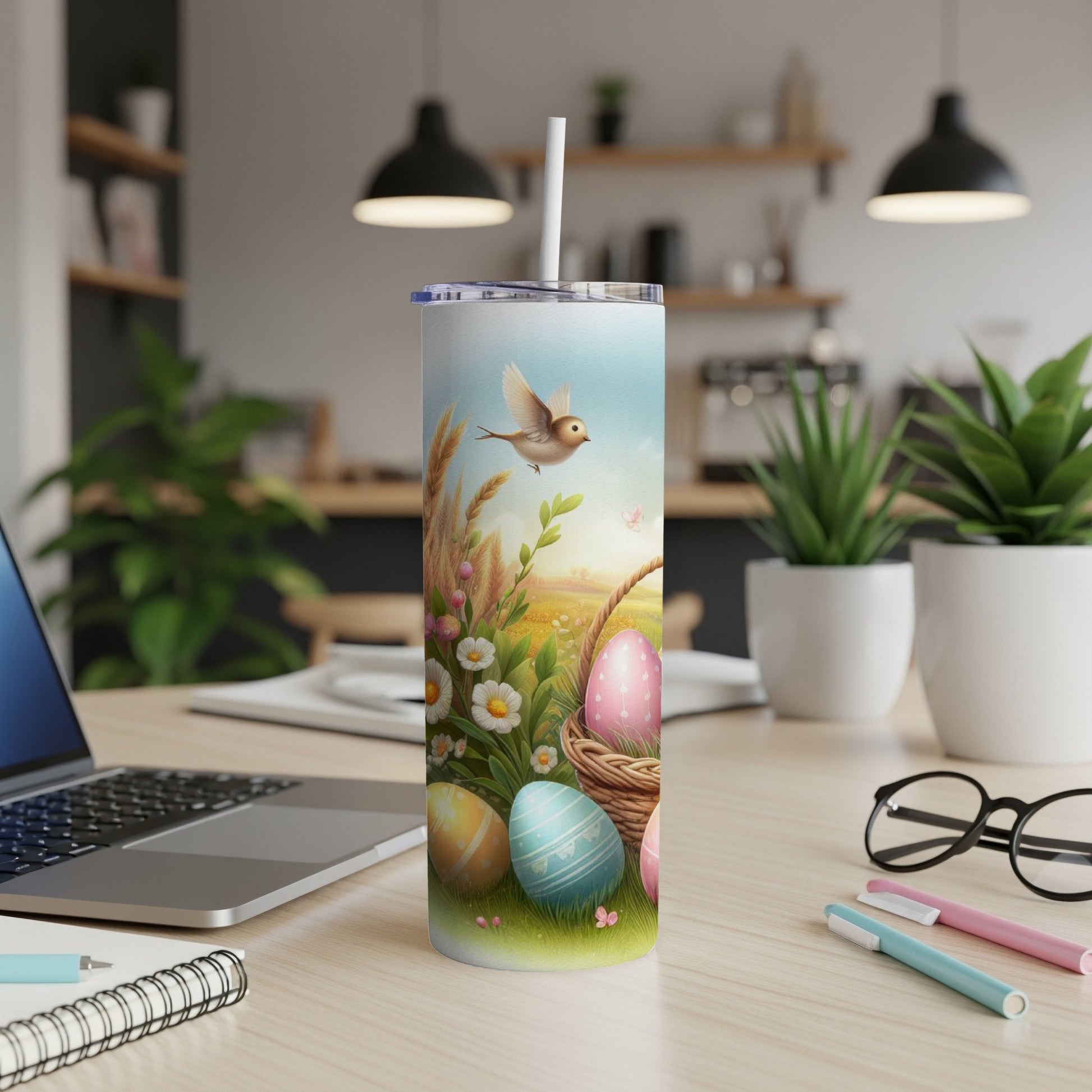 Easter tumbler with decorated eggs and a bird in a field.