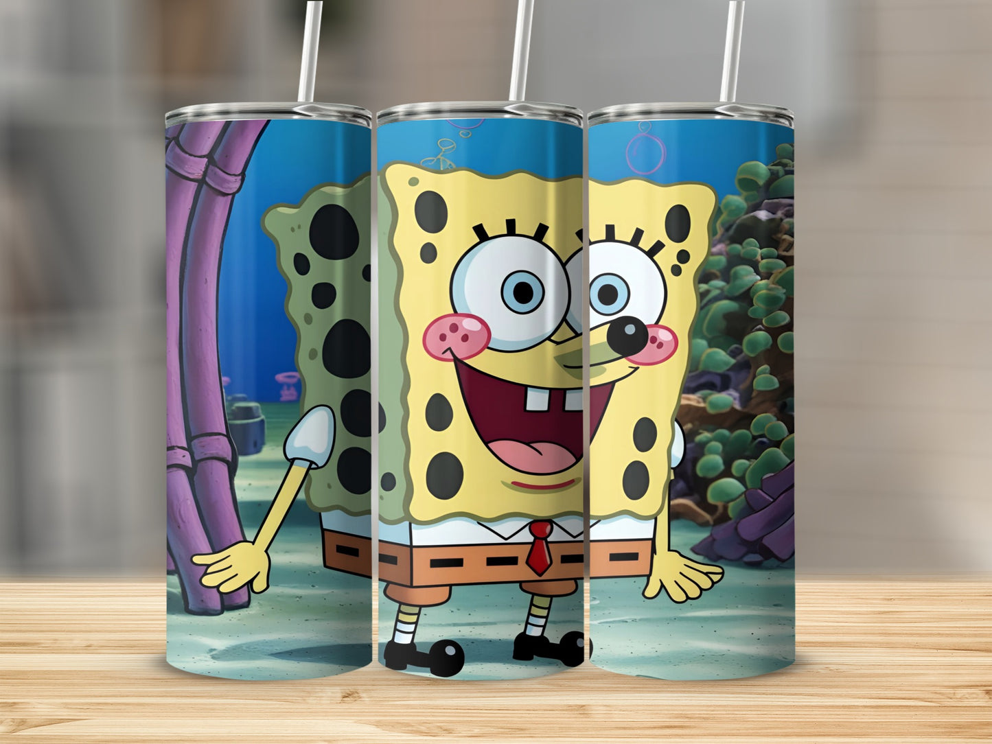SpongeBob SquarePants character with coral reef background on three tumblers.