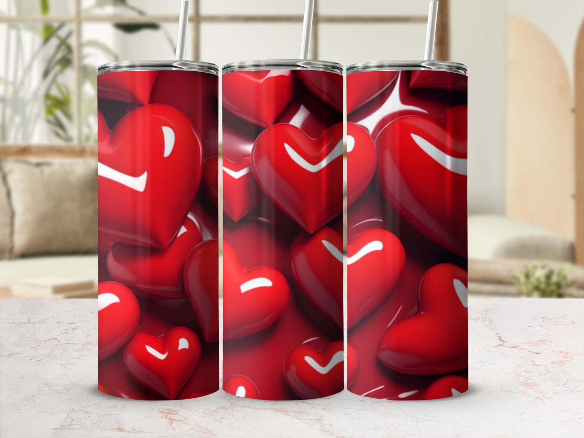 Red heart pattern on three tumblers with straws.