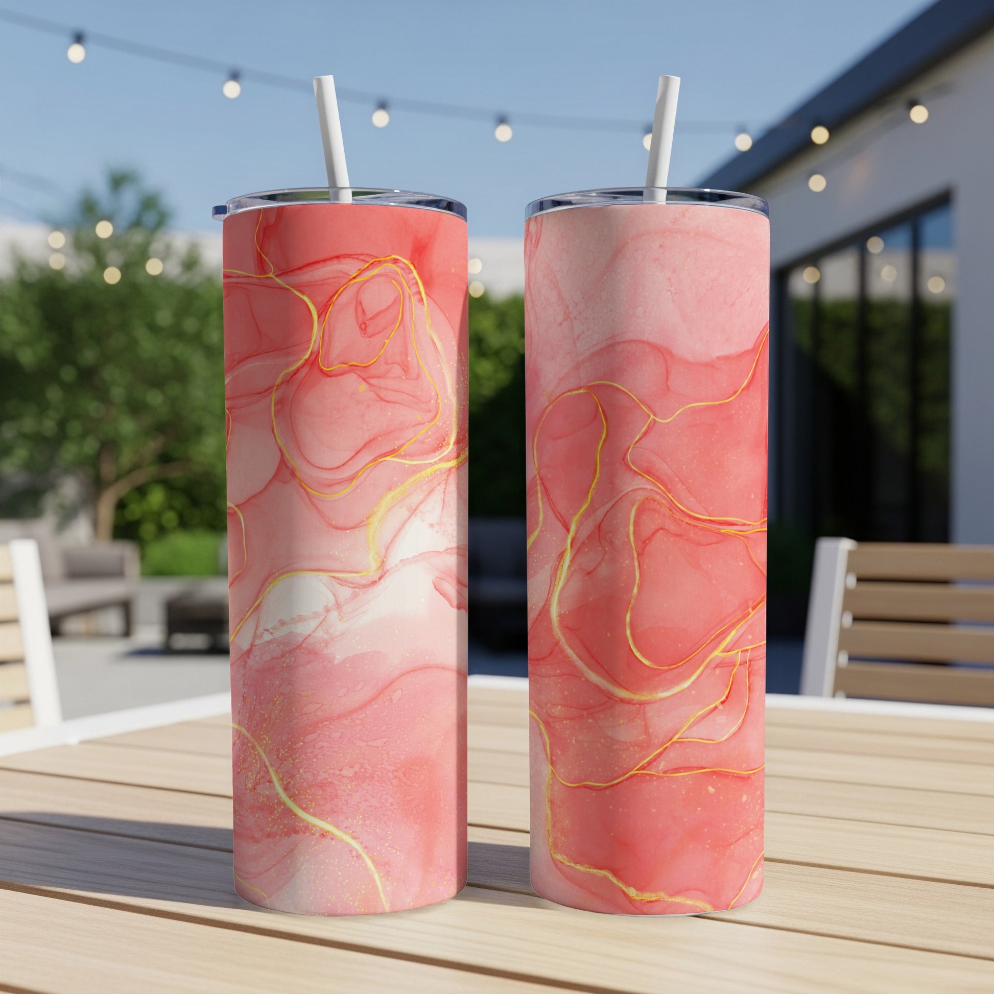 Two tall tumblers with pink and gold marbled abstract design.