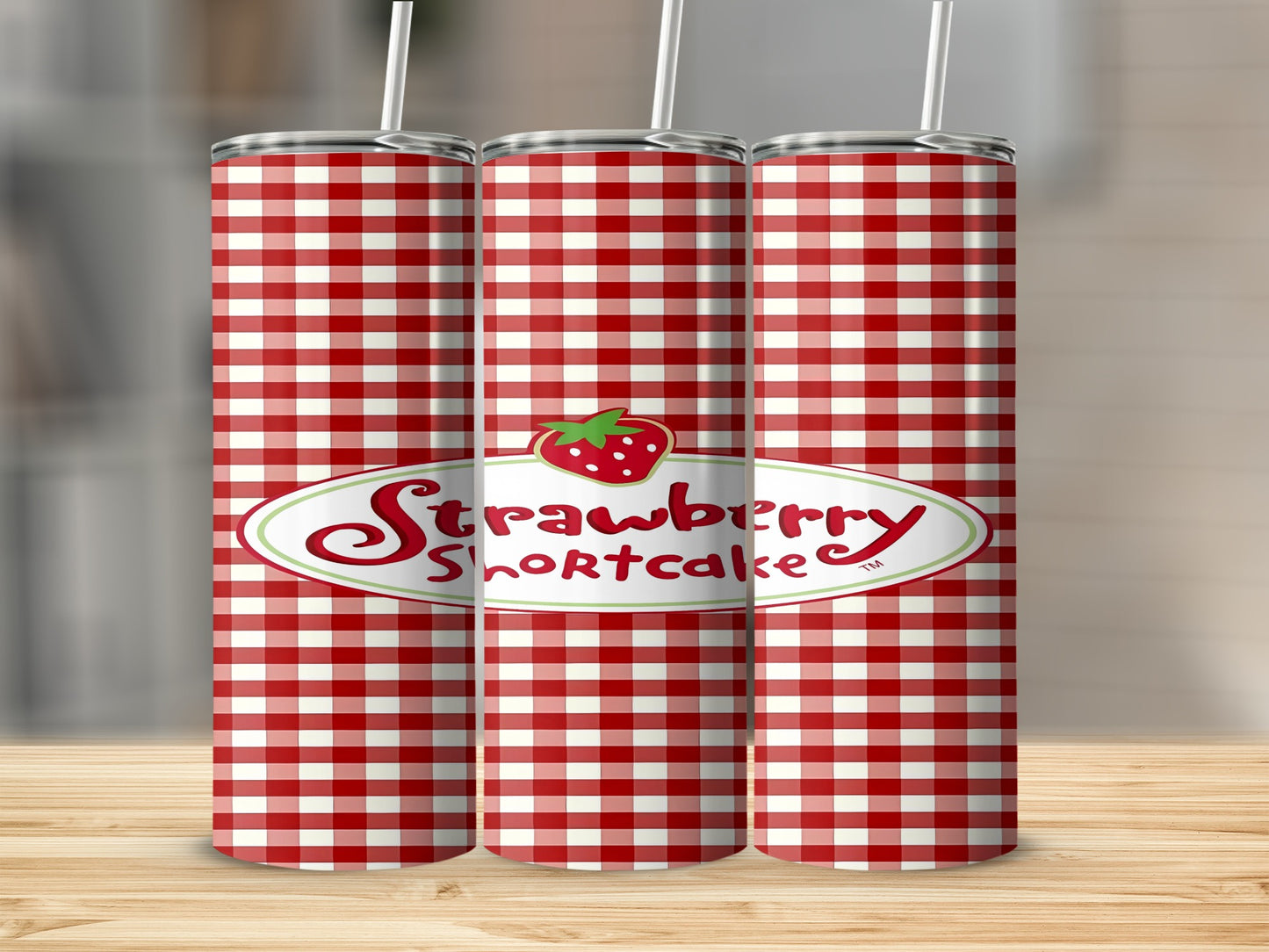 Red and white gingham patterned tumblers with Strawberry Shortcake logo.