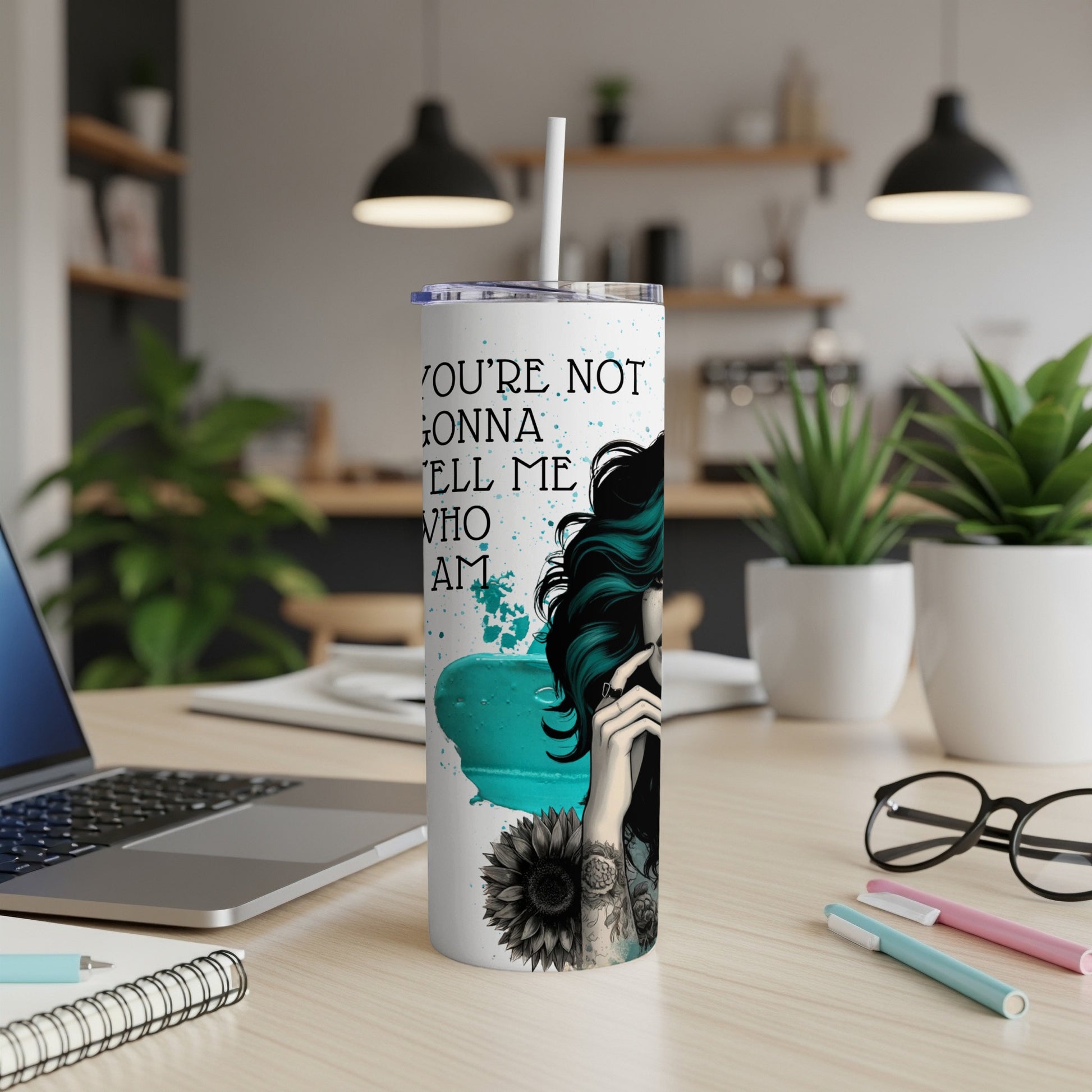 Tall tumbler with "You're not gonna tell me who I am" text and floral design.