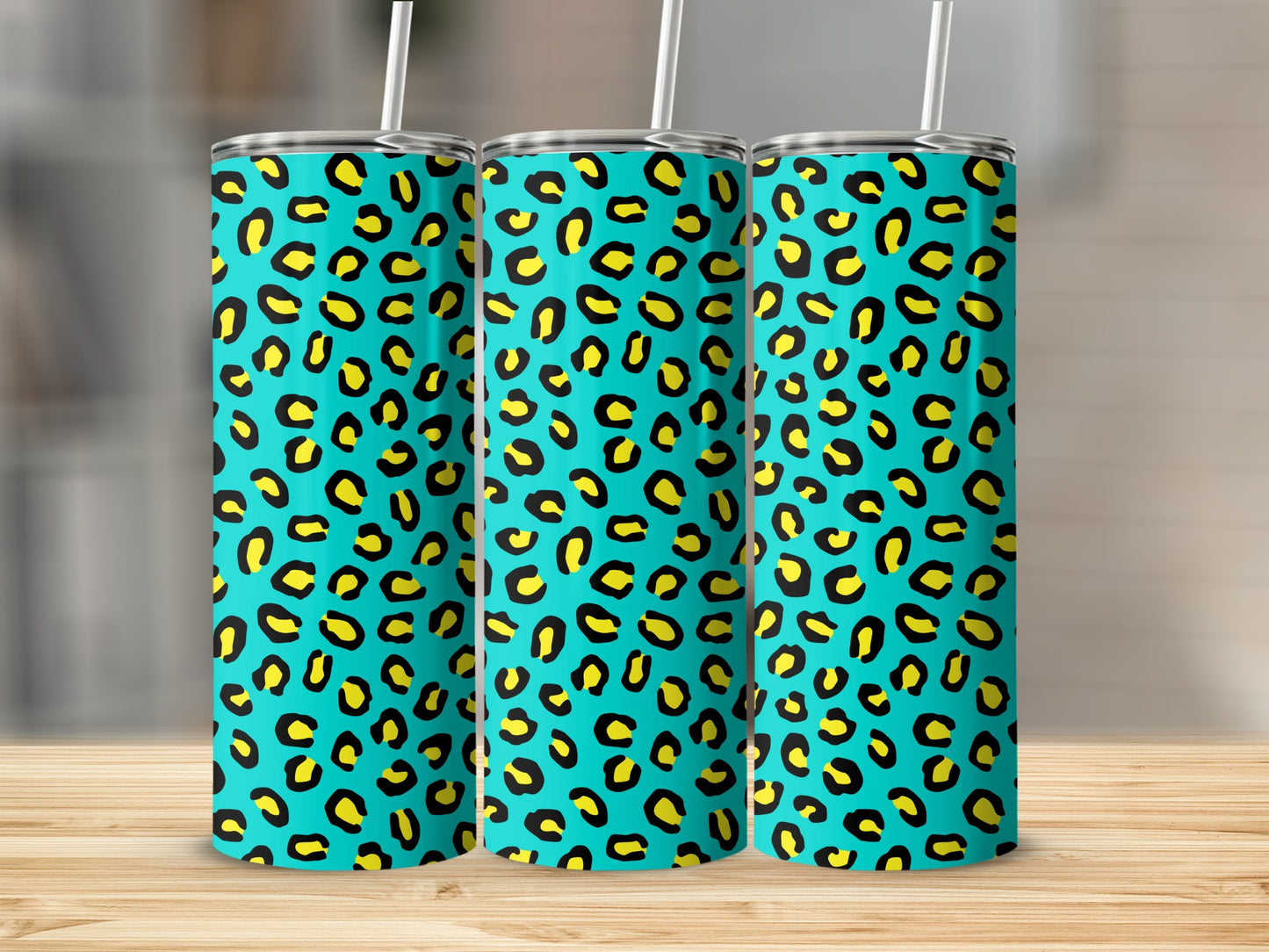 Three tumblers with a bright aqua background and black and yellow leopard print pattern.
