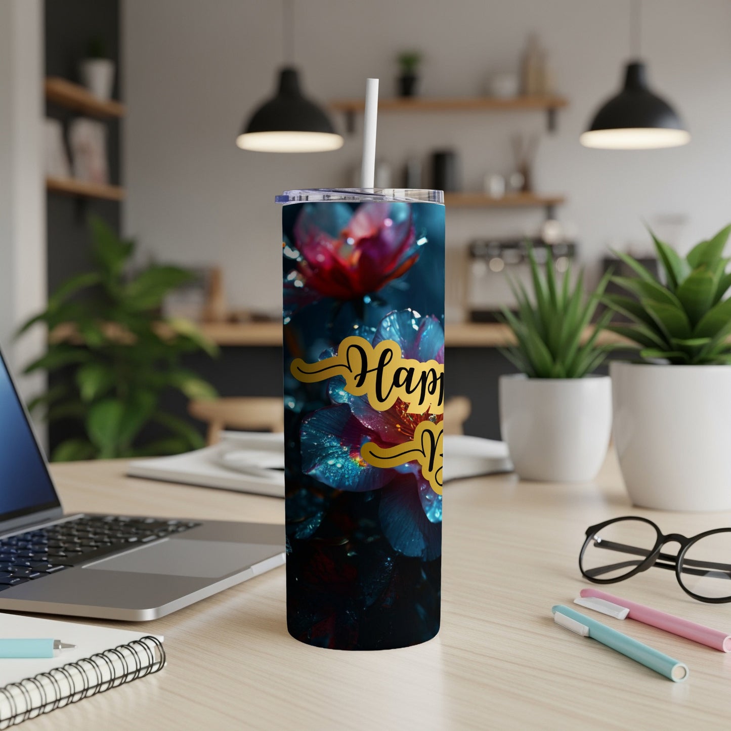 Tumbler with "Happy New Year" text and floral design on a desk.