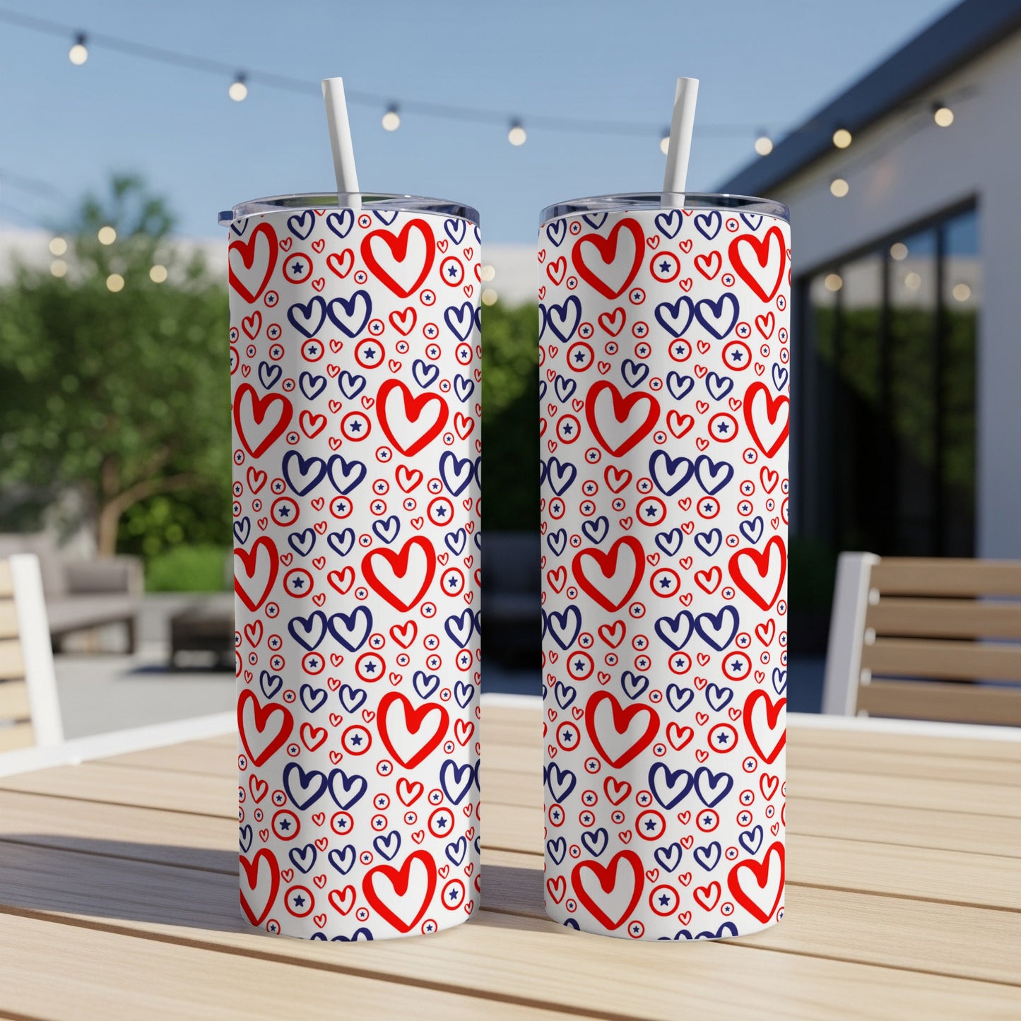 Two insulated tumblers with red and blue stars and hearts pattern.