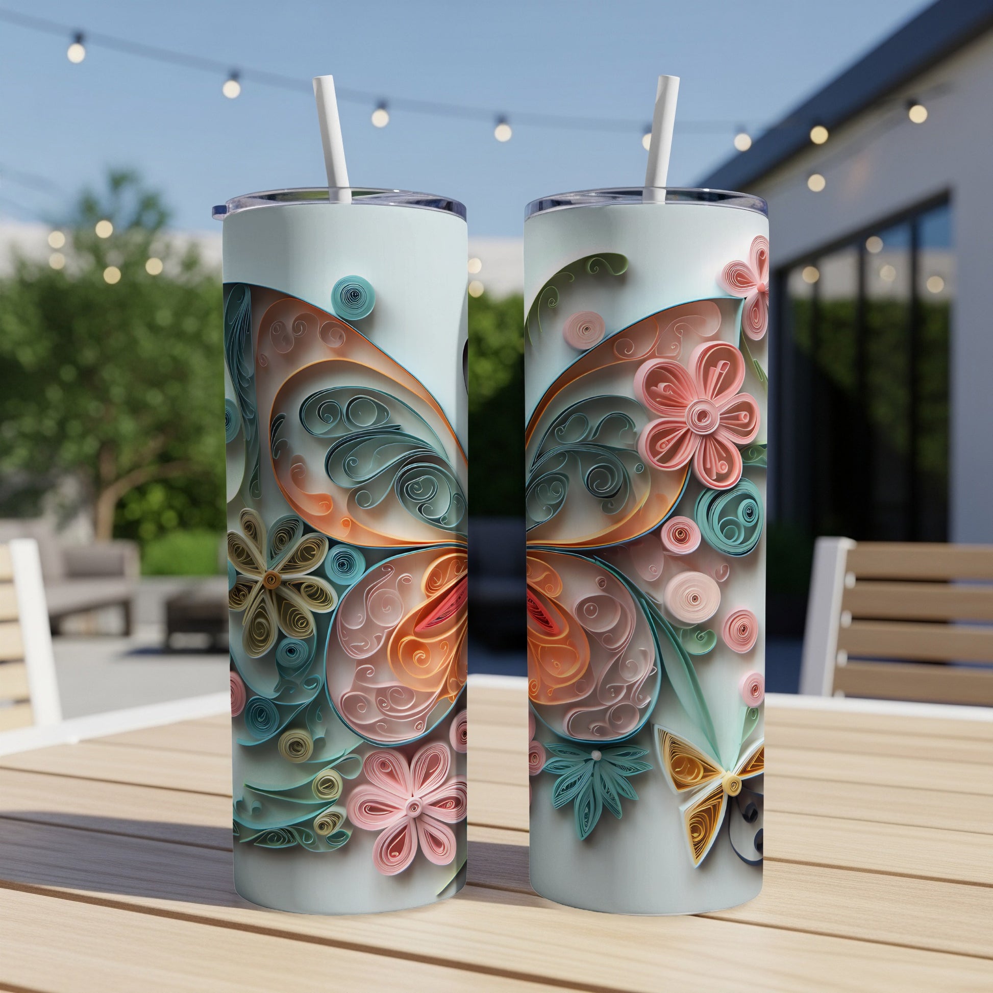 Two tumblers with a pastel butterfly and floral quilled paper design.