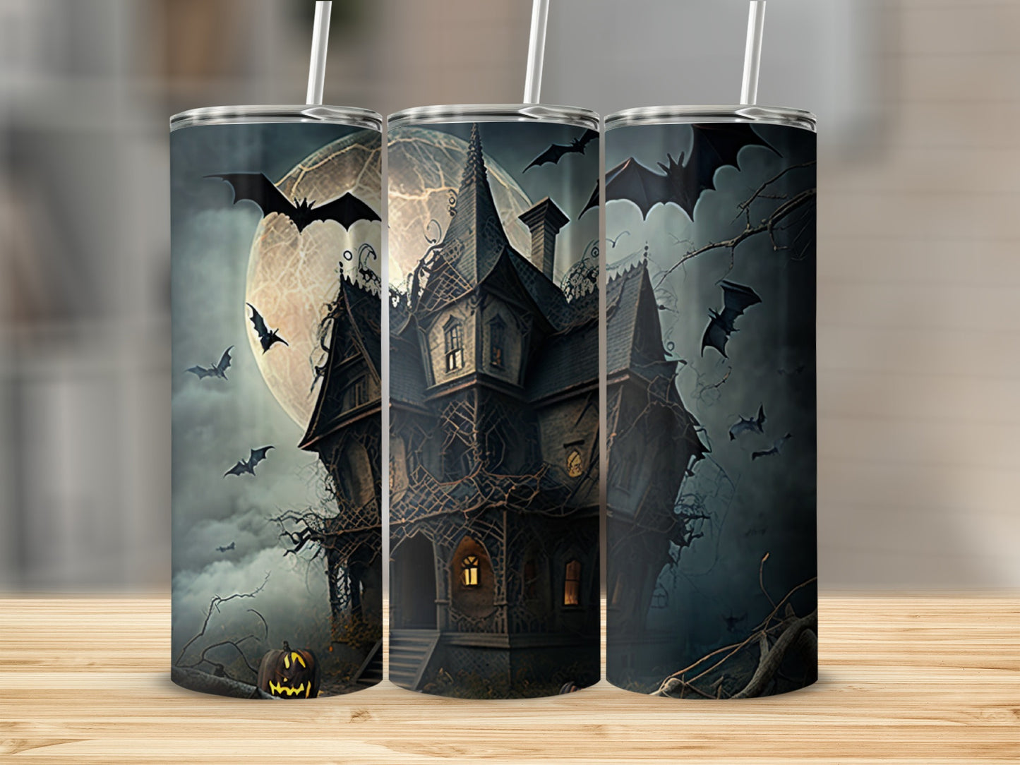 Three tumblers featuring a haunted house, full moon, and flying bats.