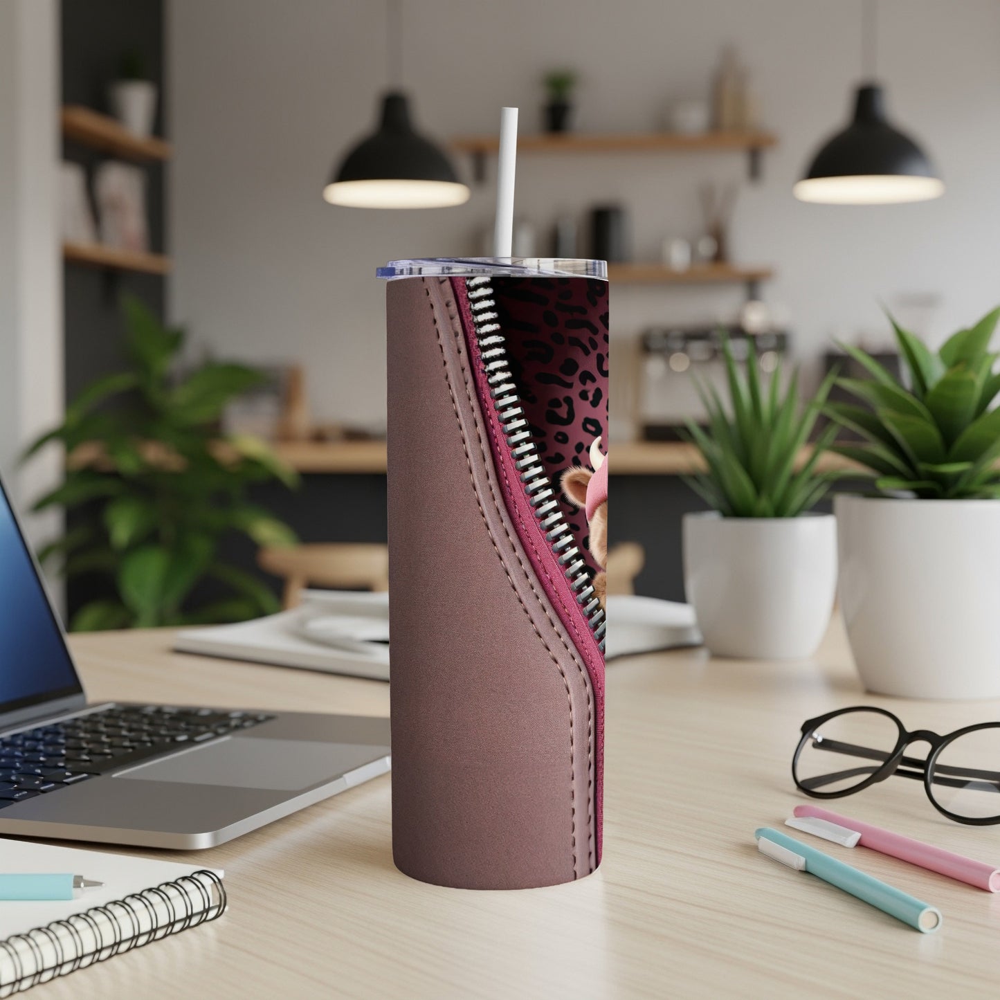 Pink leopard print zipper on a brown tumbler with a straw.