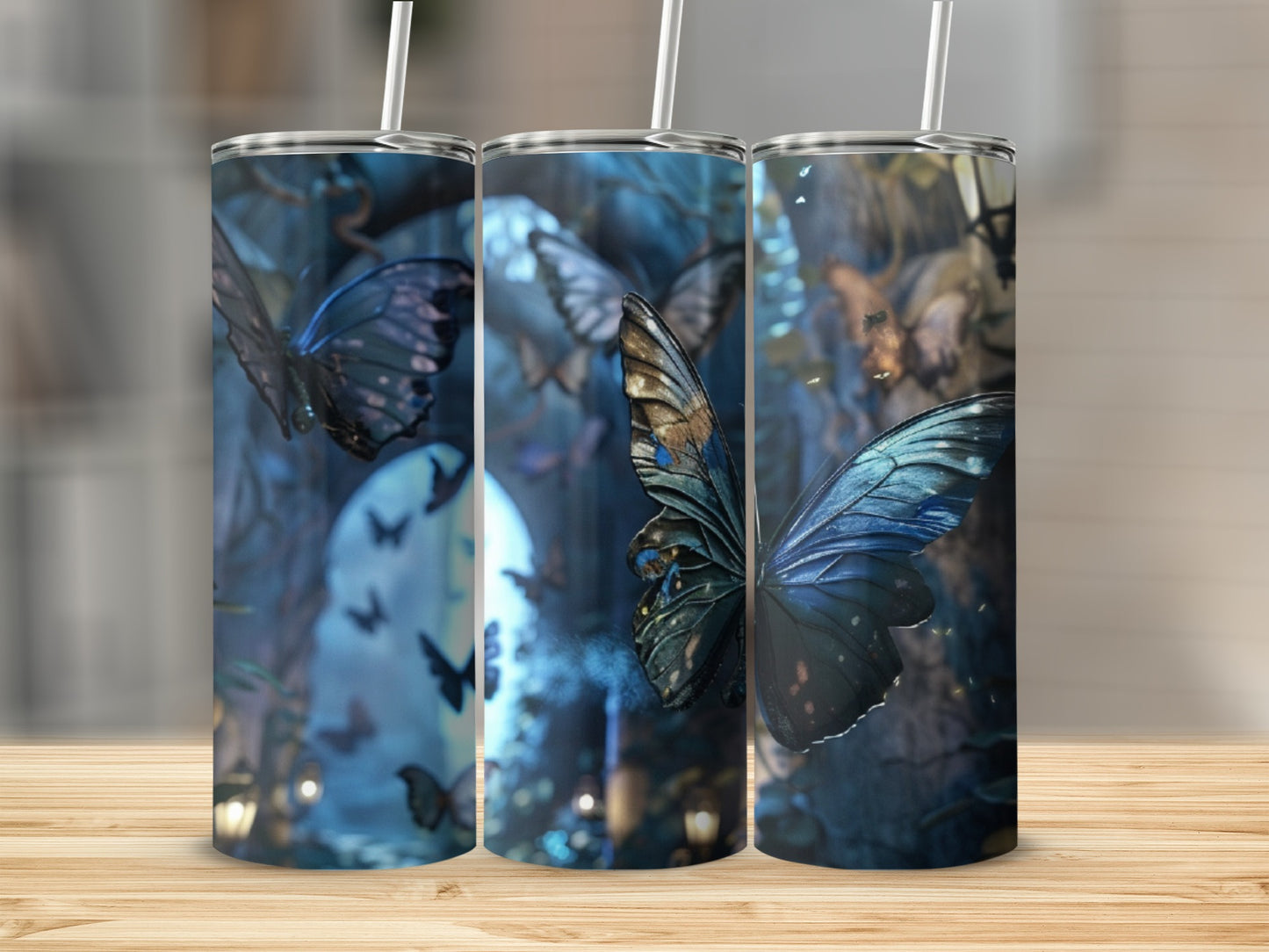 Three tumblers with a blue butterfly and glowing forest scene.