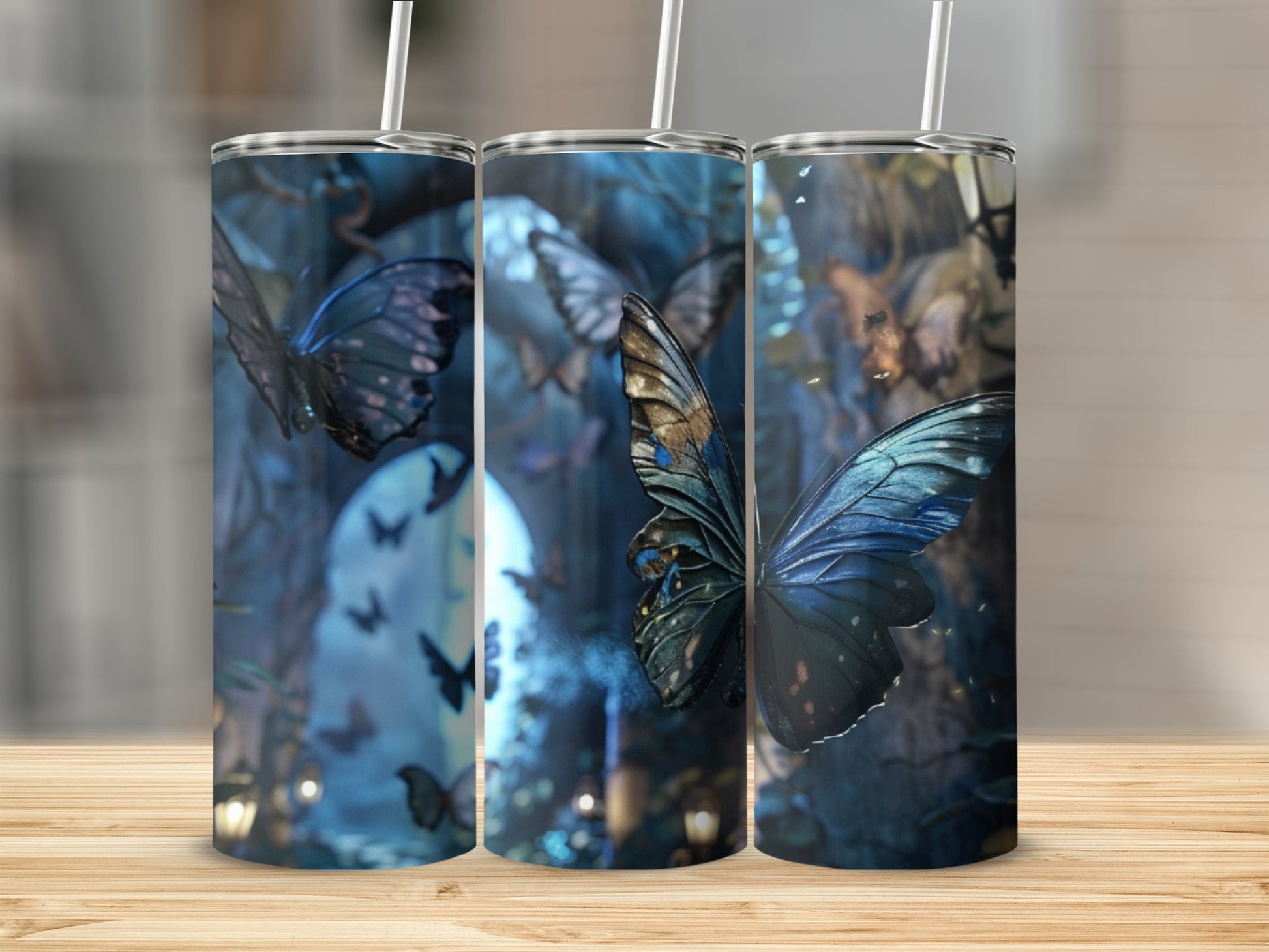 Three tumblers with a blue butterfly and glowing forest scene.