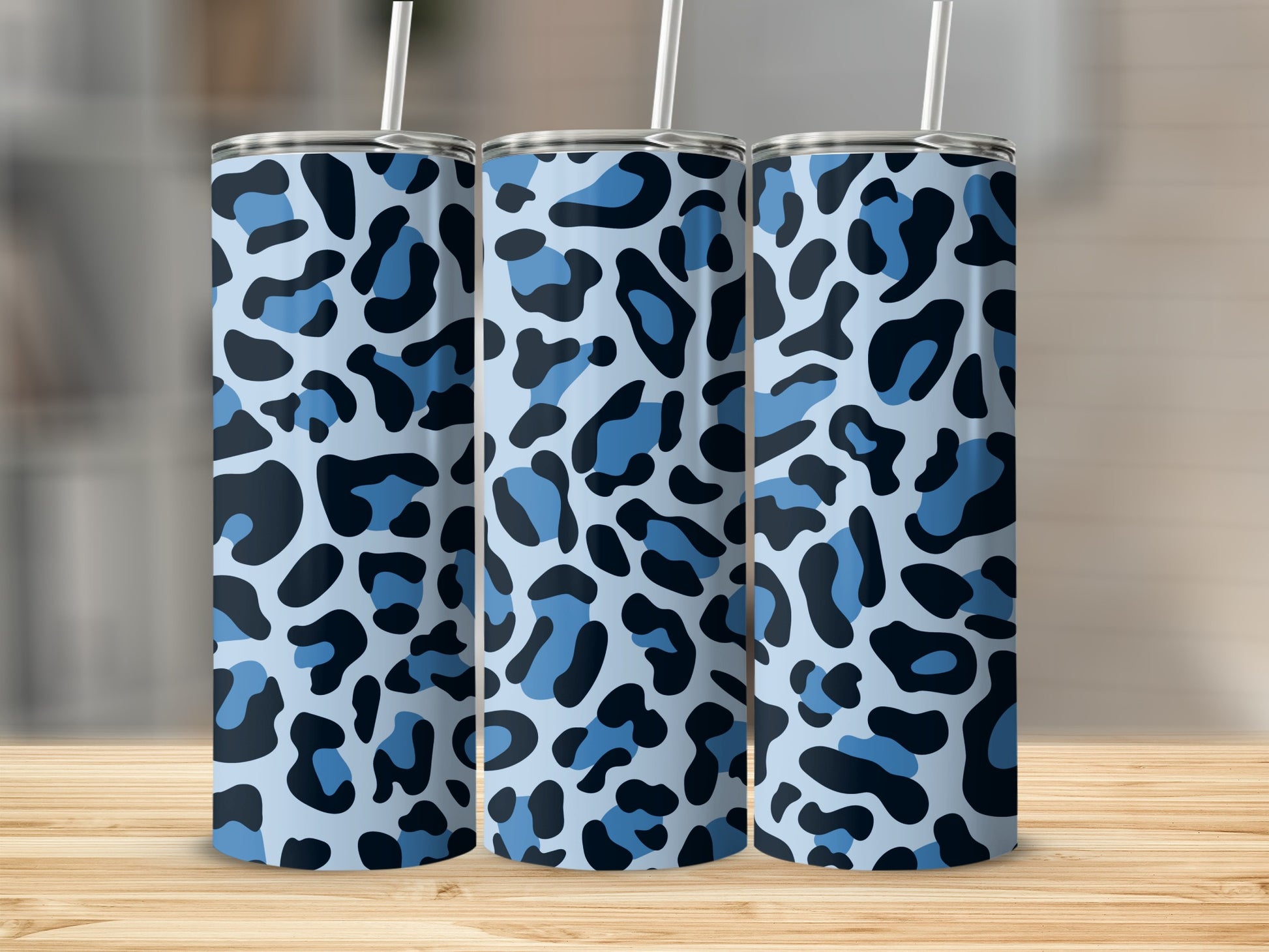 Three tumblers with light blue, dark blue, and black leopard print pattern.