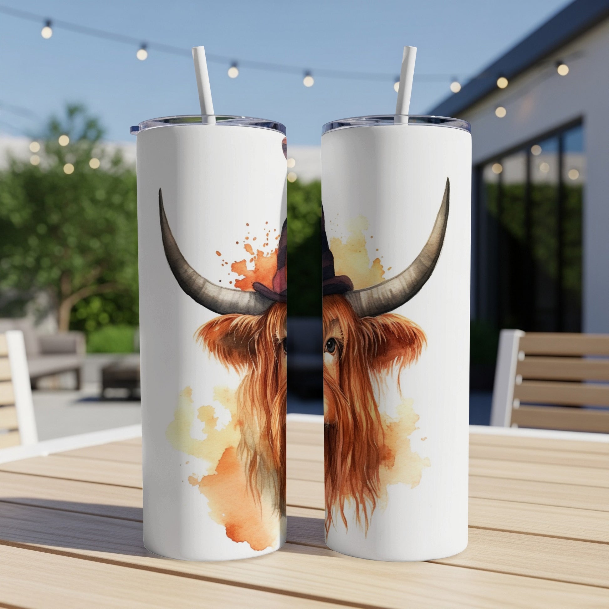 Watercolor Highland cow wearing witch hat on two tumblers.