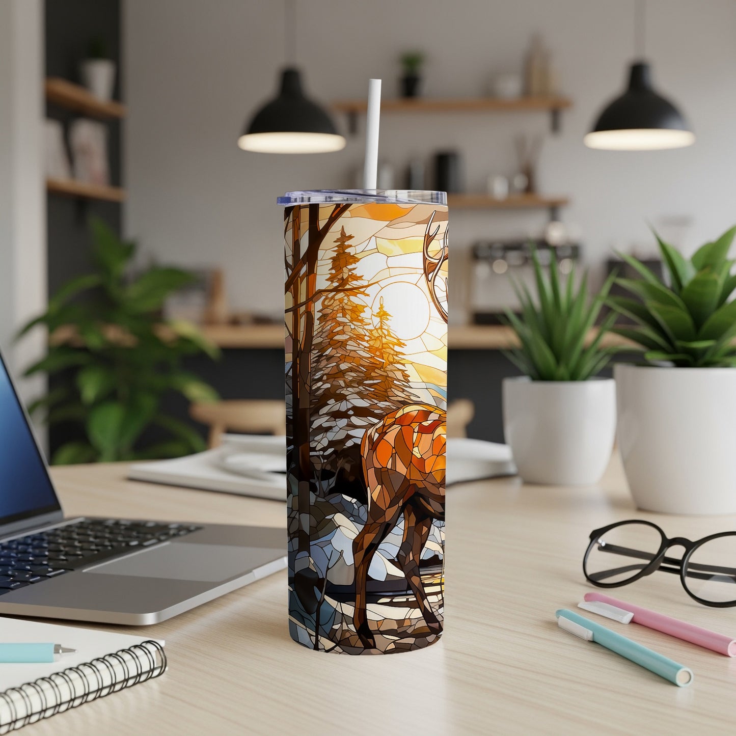 Stained glass tumbler with deer and winter forest scene.