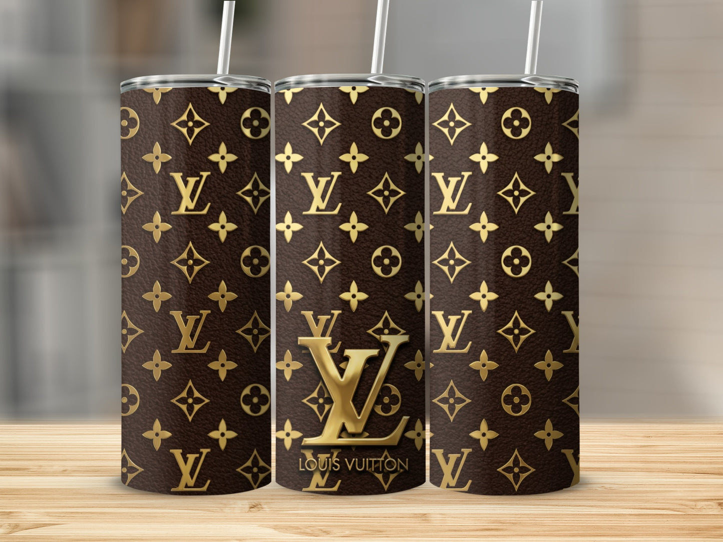 Three tumblers with a brown Louis Vuitton monogram pattern and gold accents.