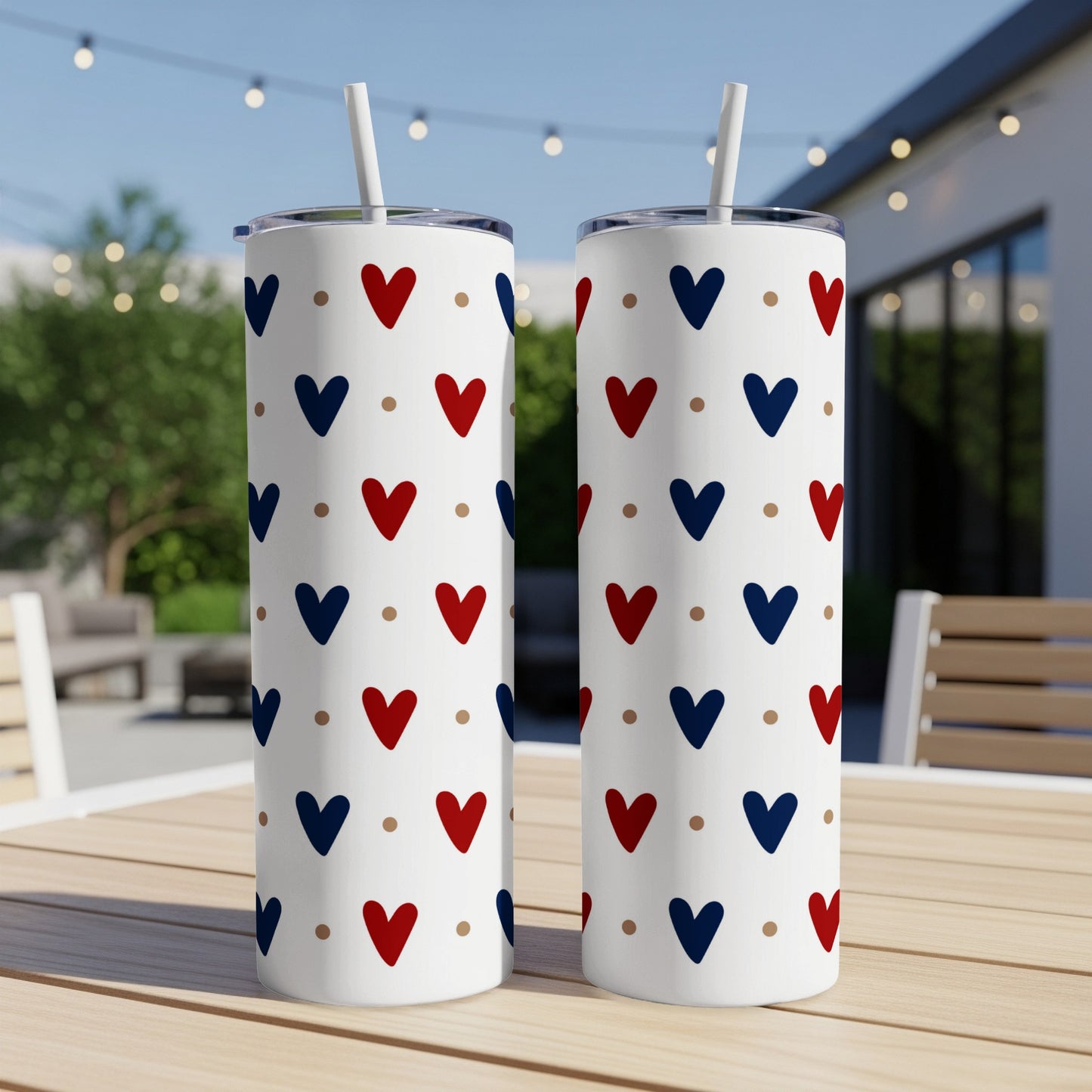 Two white tumblers with a repeating pattern of red and blue hearts and dots.