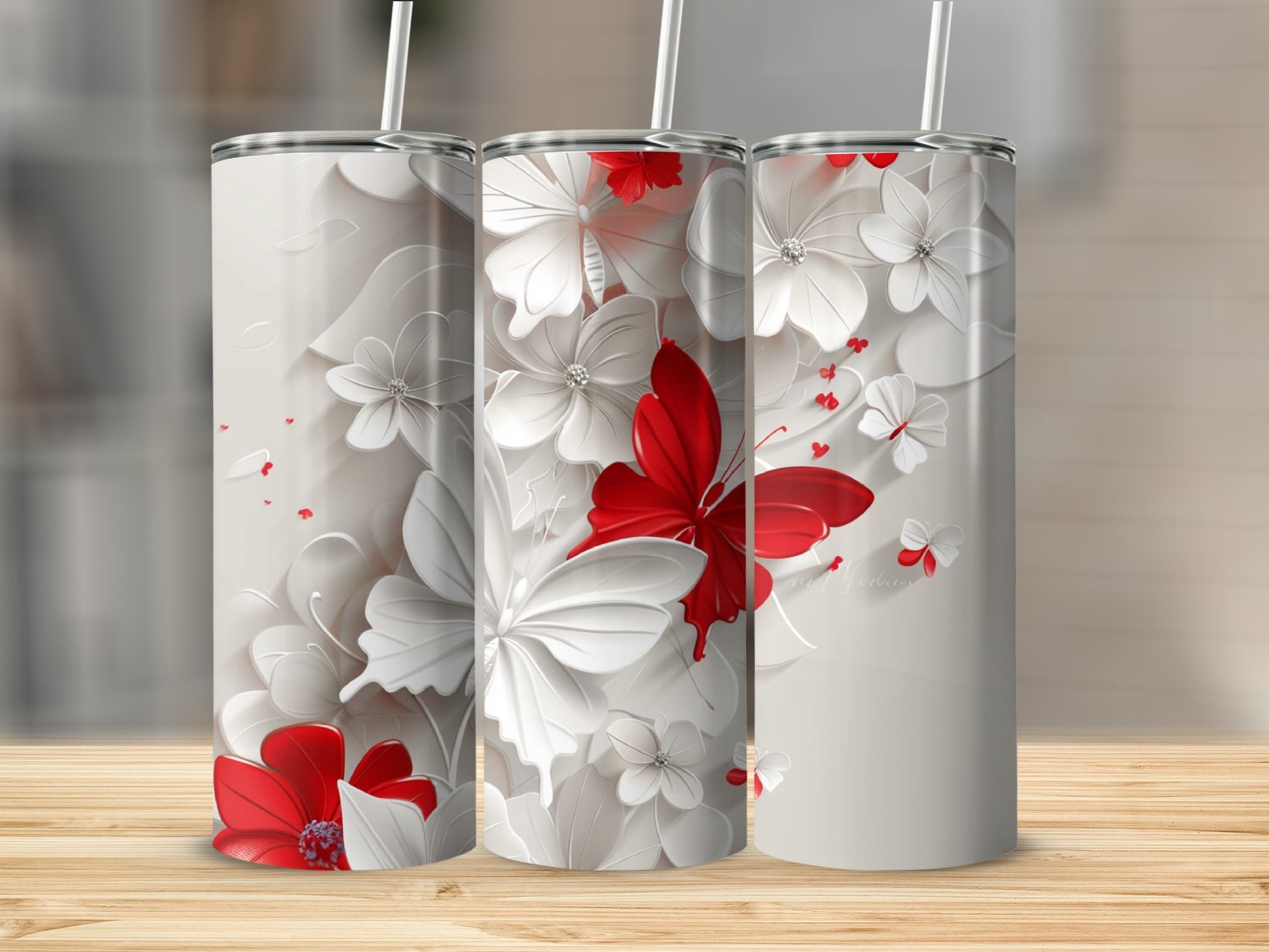 Three tumblers with a white and red floral and butterfly design.