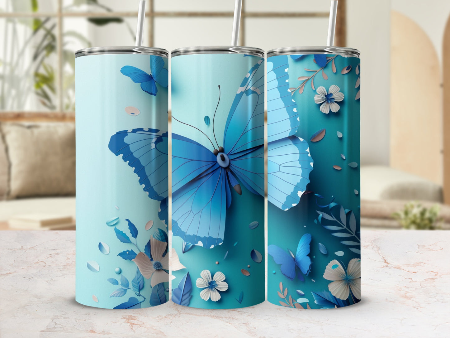 Blue butterfly and floral design on three cylindrical tumblers.