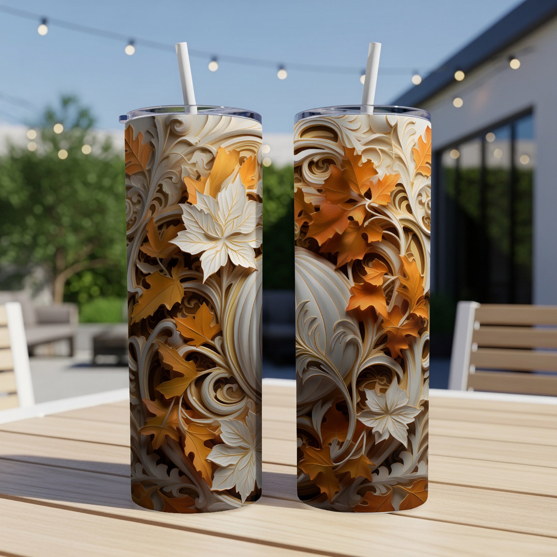 Two insulated tumblers with autumn leaf and scrollwork designs.