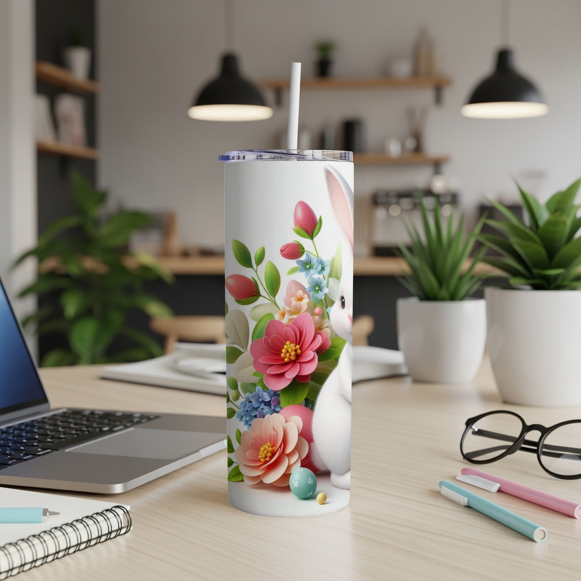 White tumbler with Easter bunny, flowers, and eggs.