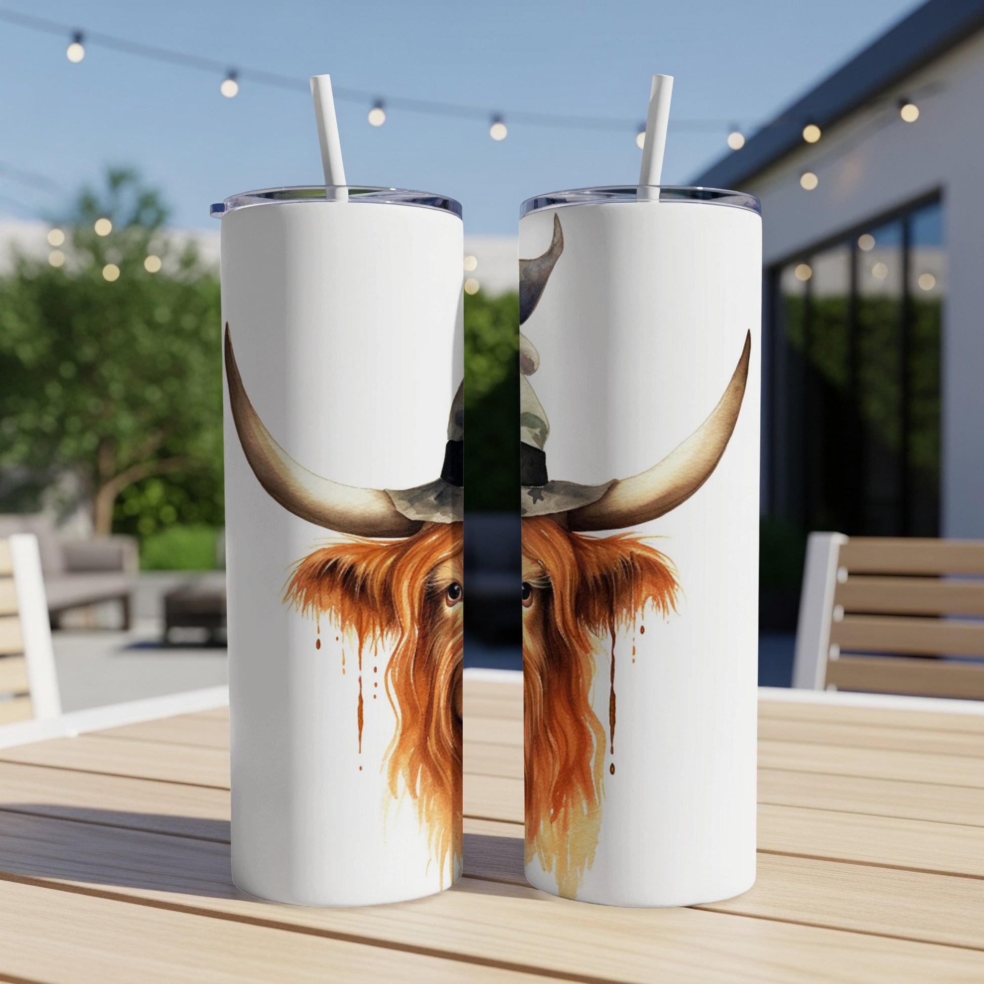 White tumbler with Highland cow illustration wearing a hat.