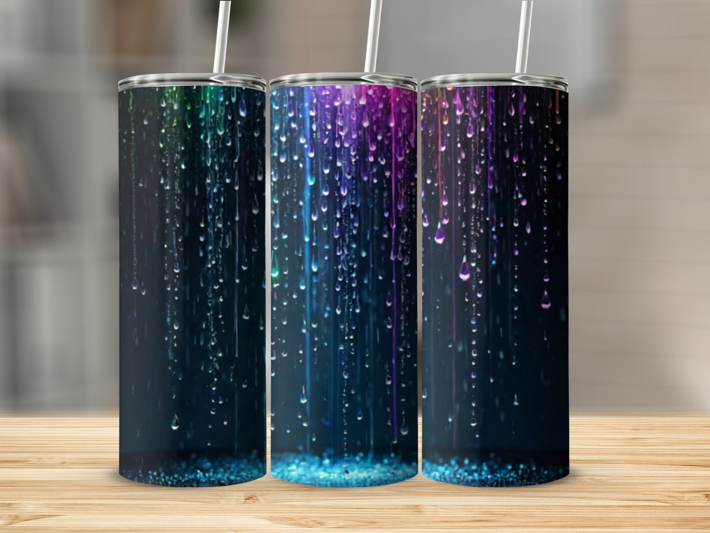 Three tumblers with colorful, dripping watercolor designs.