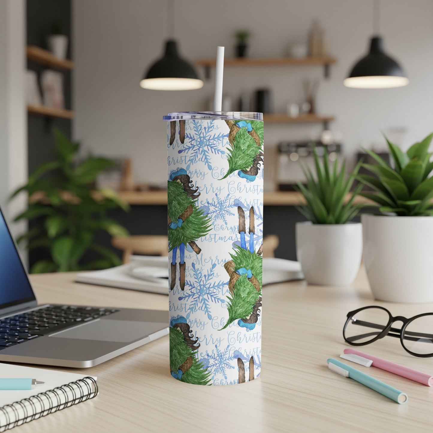 White tumbler with "Merry Christmas" text and blue snowflake pattern.