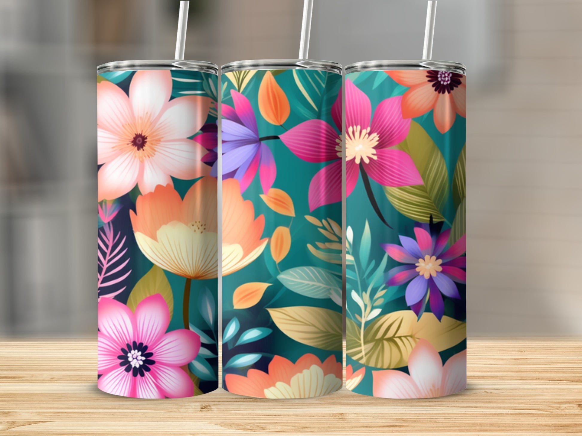 Three tall tumblers with vibrant floral designs and white straws.