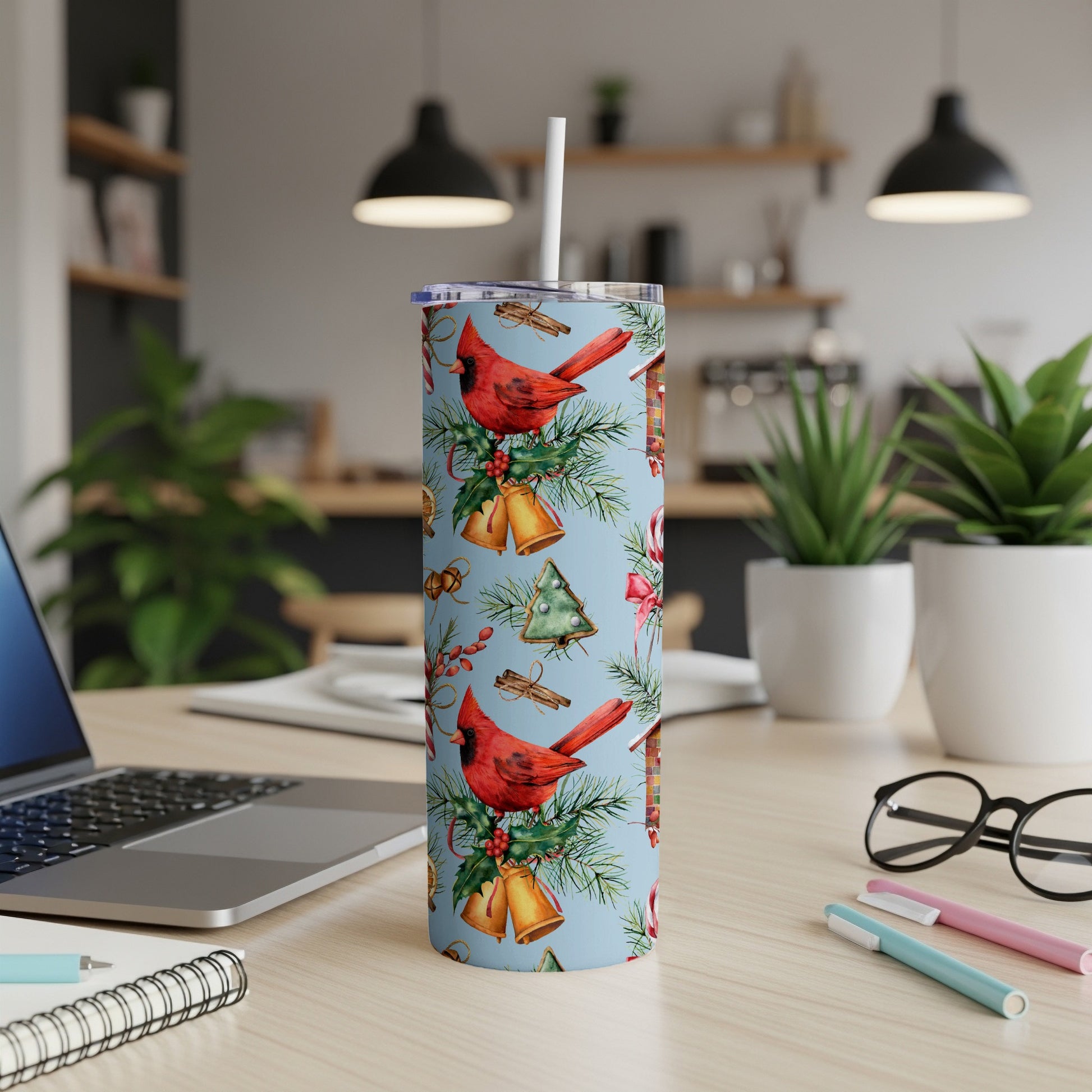 Blue tumbler with cardinals, bells, and evergreen sprigs.