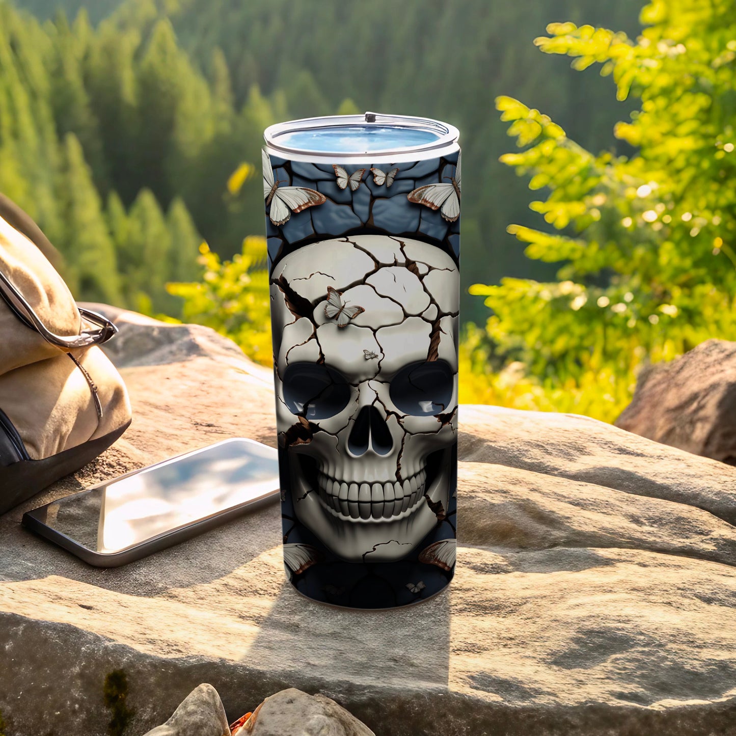 Cracked skull tumbler with butterflies and a forest background.