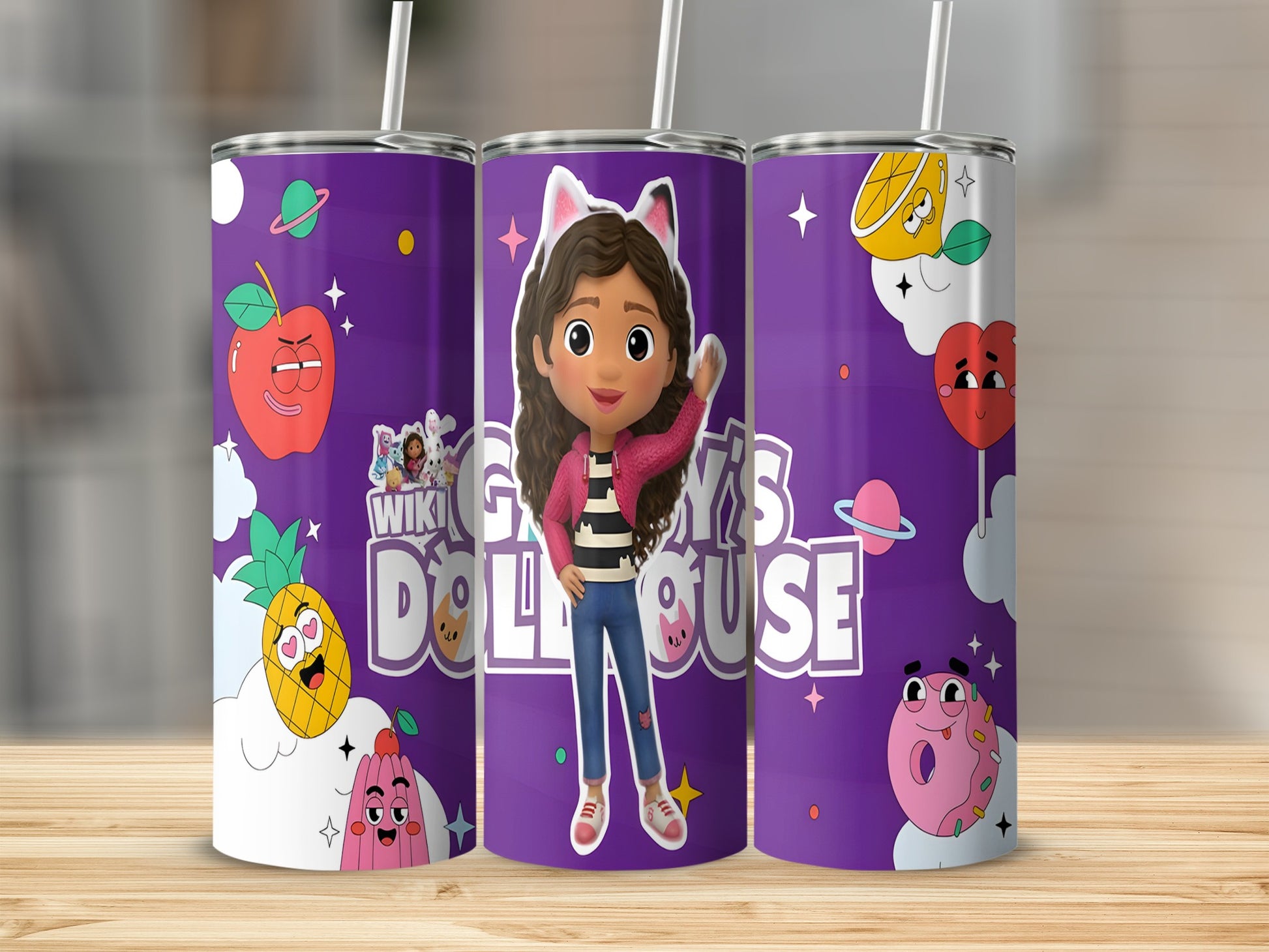 Gabby's Dollhouse tumbler with Gabby, pineapple, apple, and planet designs.