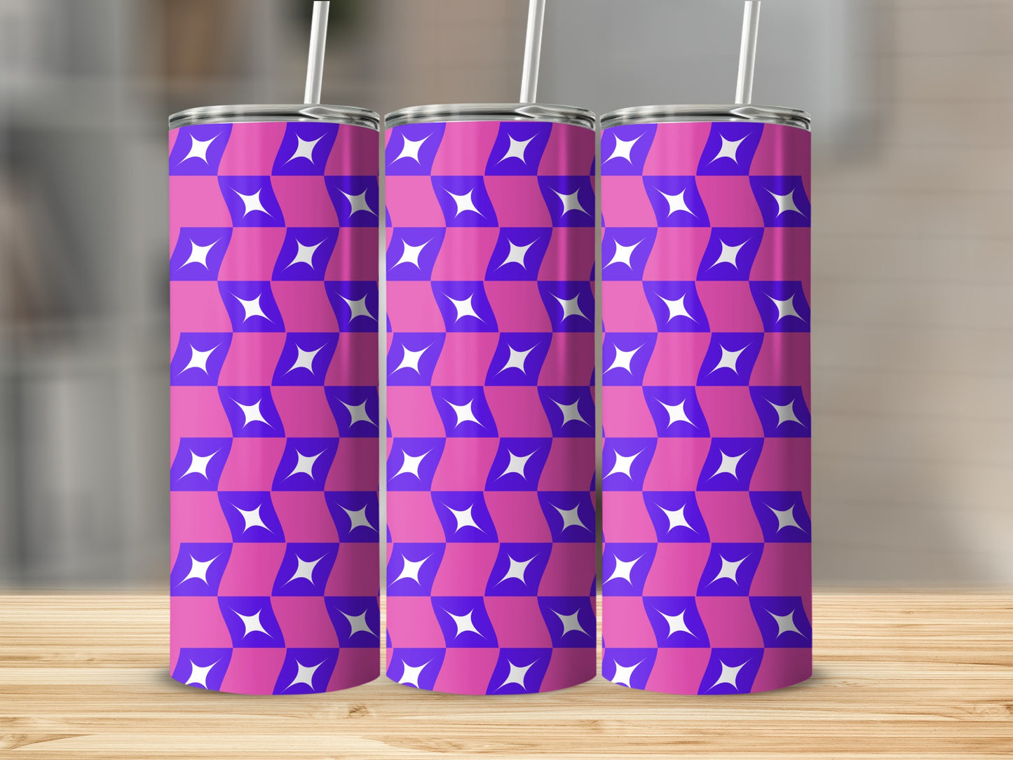 Three purple and white geometric patterned tumblers on a wooden surface.