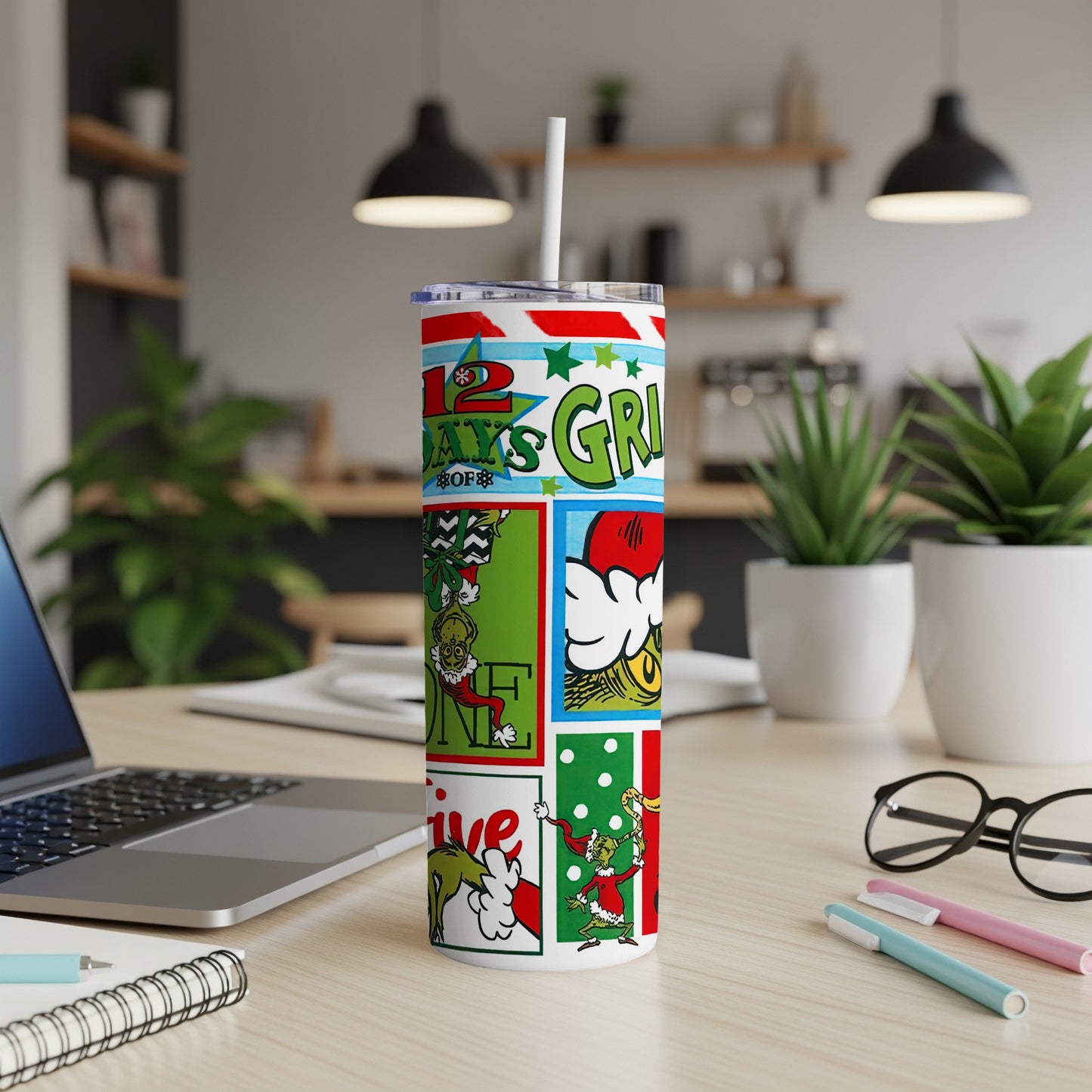 Grinch-themed 12 Days of Christmas tumbler with straw on a desk.