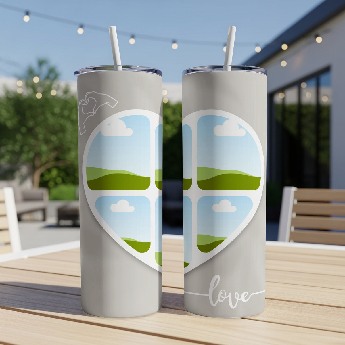 Two grey tumblers with a heart design showcasing landscape photos and the word "love".