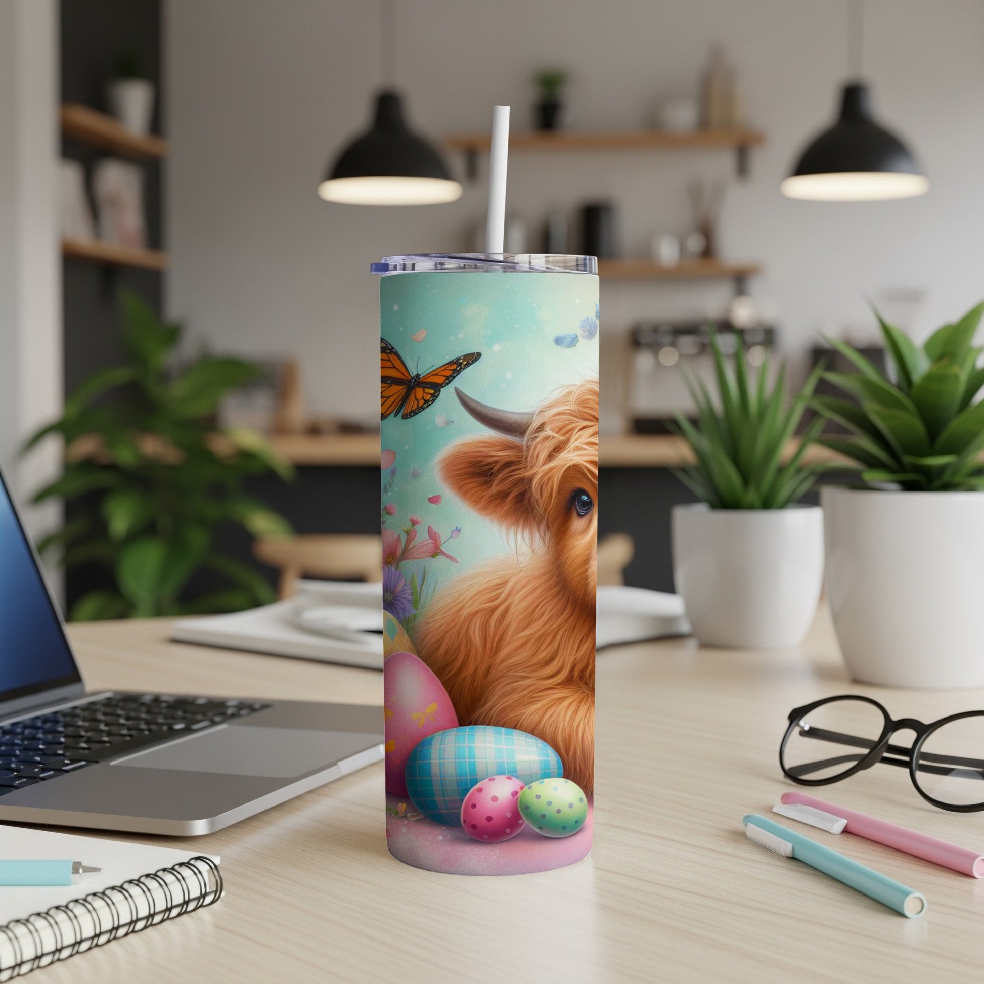 Highland cow with Easter eggs and butterfly, on a blue, teal, and pink speckled tumbler.